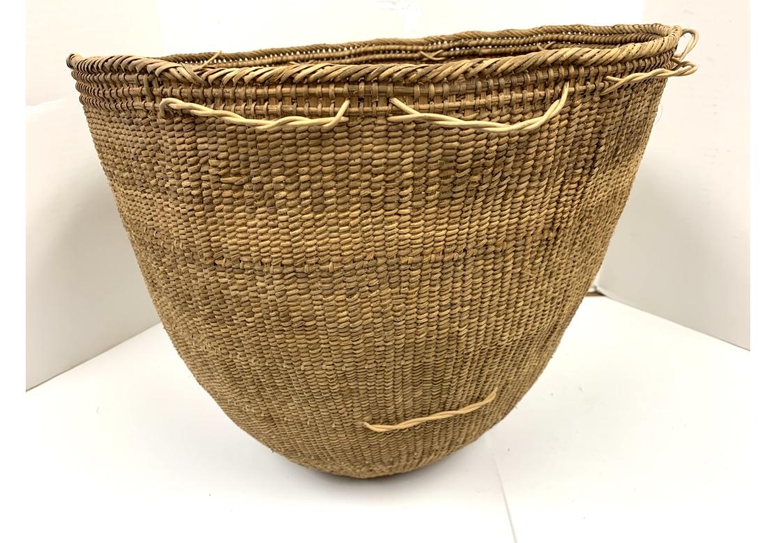 A fine pair of tightly woven burden or gathering baskets from the South American Yanomami People of the Brazilian Rainforest. Very strong and woven from Palm fiber, the baskets are used for gathering food and strong enough to carry firewood. One