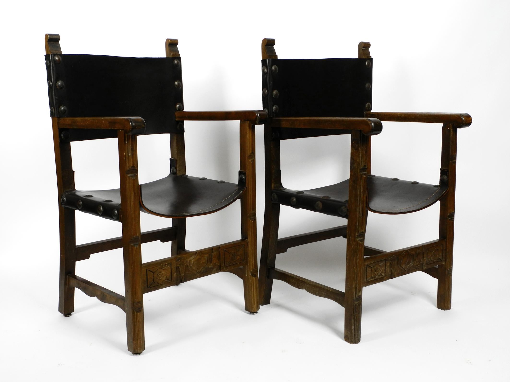 Two large 1930s massive knight armchairs made of solid wood. 
Seat and back are made of thick core leather. Made in Spain in the 1930's.
The previous owner bought it a long time ago in an antique shop in Spain.
The wooden frame, built to last,