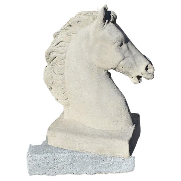 A pair of two cast concrete stone horse busts. Such a wonderful way to add a regal look to an entryway. (Or perhaps even a driveway.) Each piece depicts the bust of a horse with a flowing mane. Each sits upon a small square base.

We also have