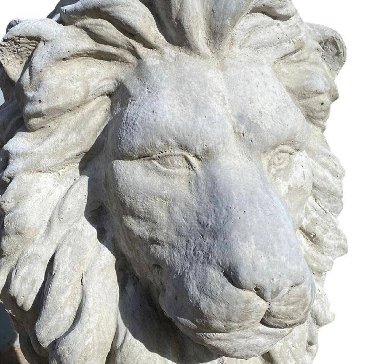 A pair of two cast concrete stone lions. Such a wonderful way to add a regal look to an entryway. (Or perhaps even a driveway.) Each lion sits on it’s hind legs, with his front paws outstretched and it’s mane flowing down his back. It stands on a