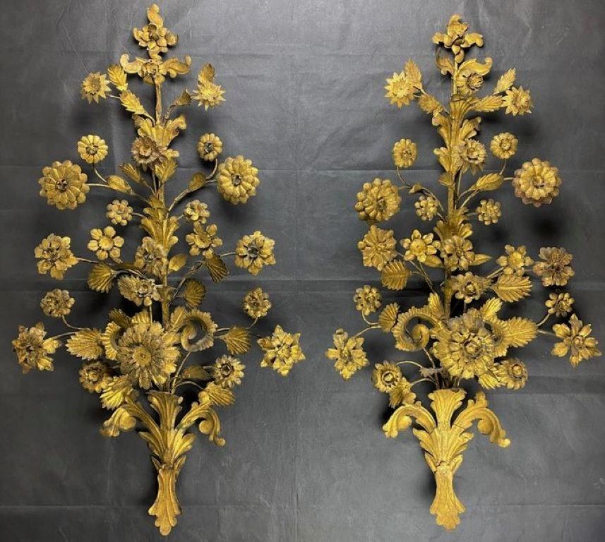 Two extraordinary decorative wall sconces, Venice, Italy, mid-19th century. Finely handcrafted of wrought iron, gilded and masterful attention to detail decorated with floral motifs. Gilding very well preserved with splendid patina of the period,