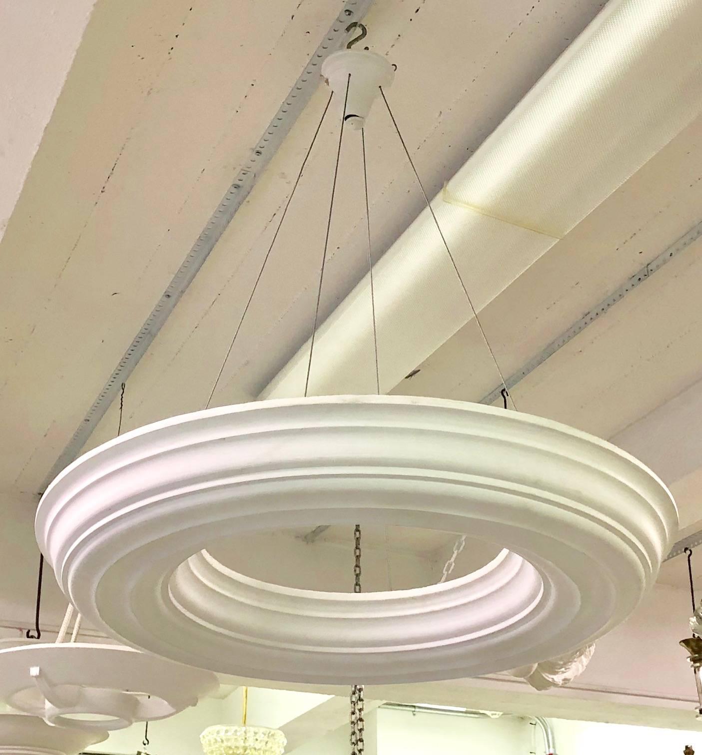 Elegant French Late Art Deco style plaster chandeliers / pendants in the Modern Neoclassical tradition. These dramatic, yet minimal pieces are in the form of an open ring and in the style of  the French master designer of the 1930's: Serge Roche.