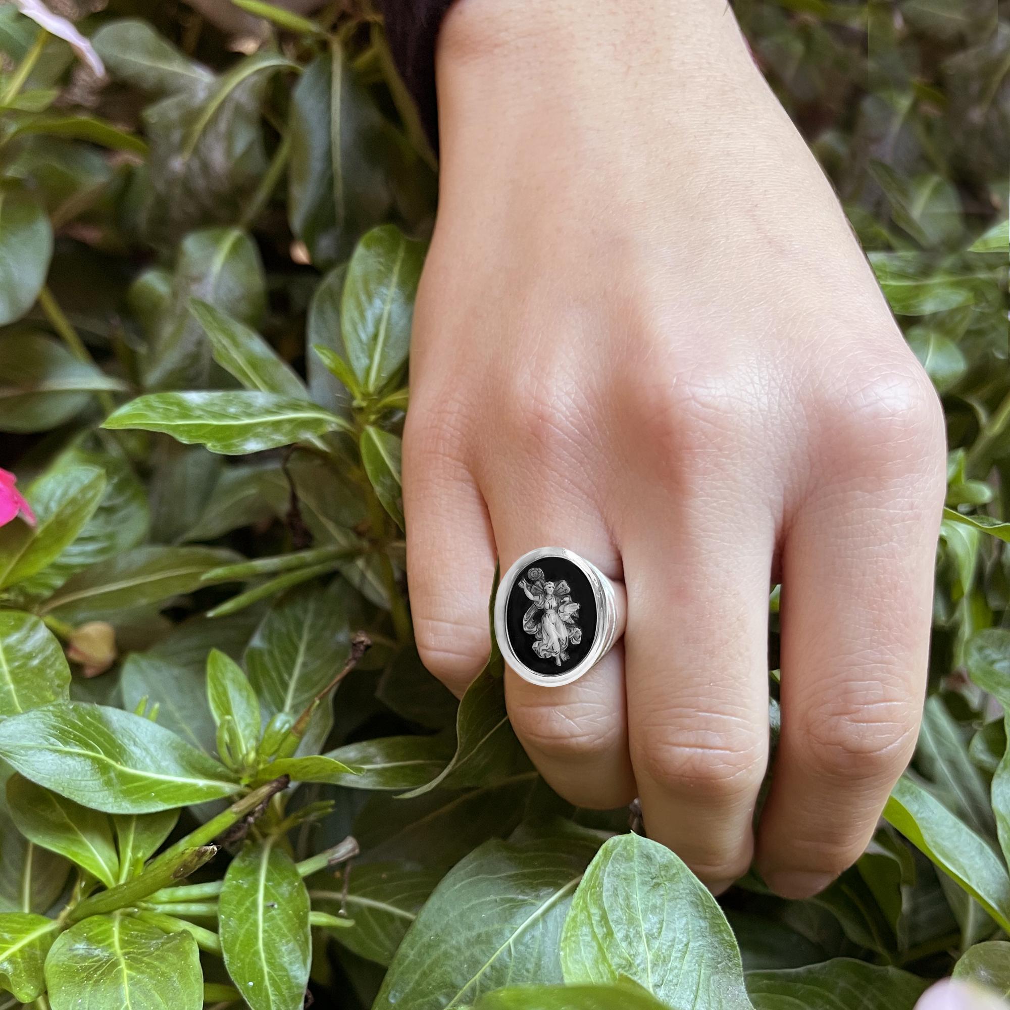 This sterling silver ring has been set with a post classical Roman cameo carved in two-layer agate (black and white) depicting a winged Nike ( Victory )  with a swan and a rising sun. The post-classical period begins with Constantine in 312 AD; the