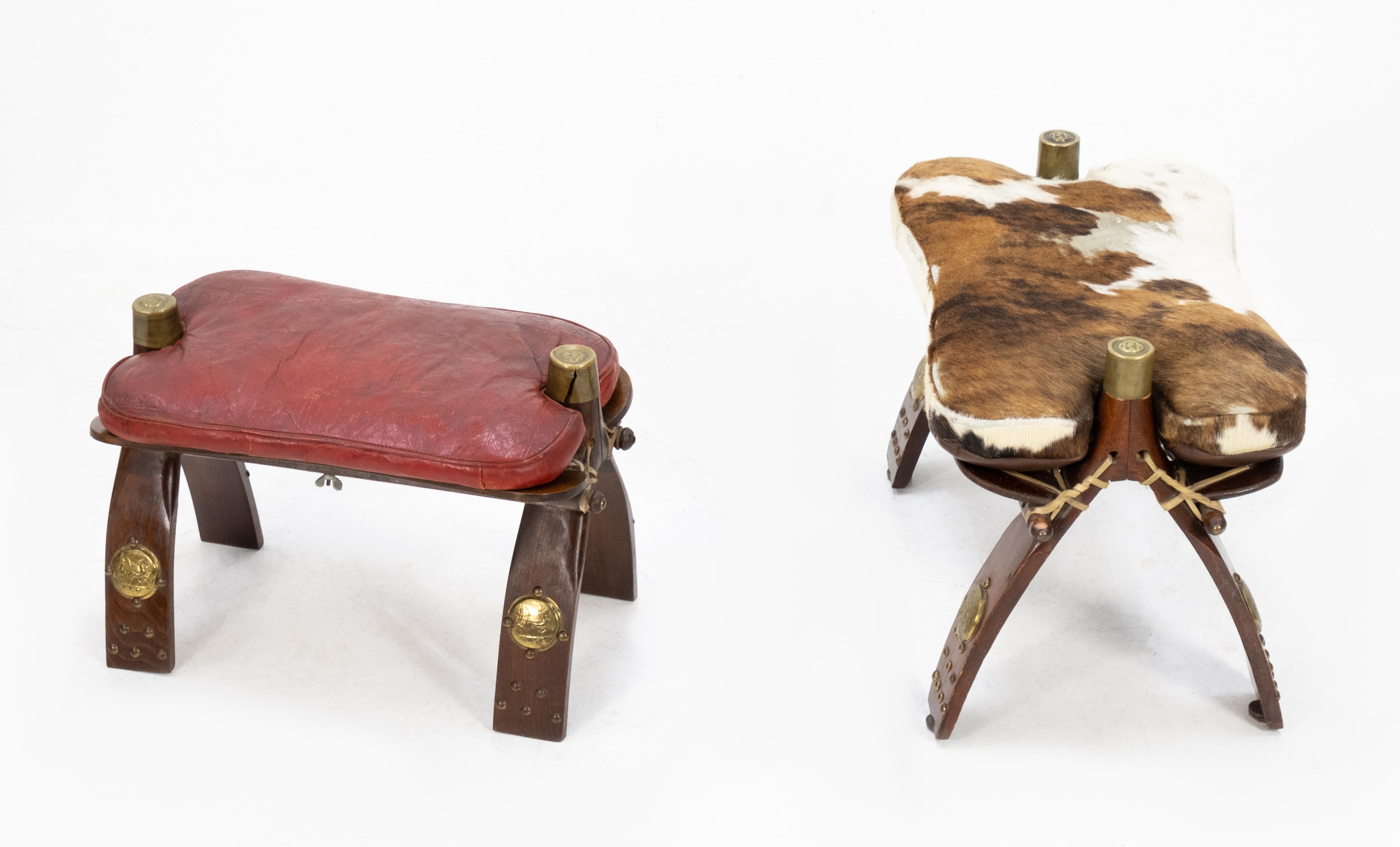 Two camel saddle foot stools from Egypt where bring back by the tourists in the 1960s. Love these little stools. One in red leather the other comes with a cowhide. In a used condition. So decorative.
And useful.