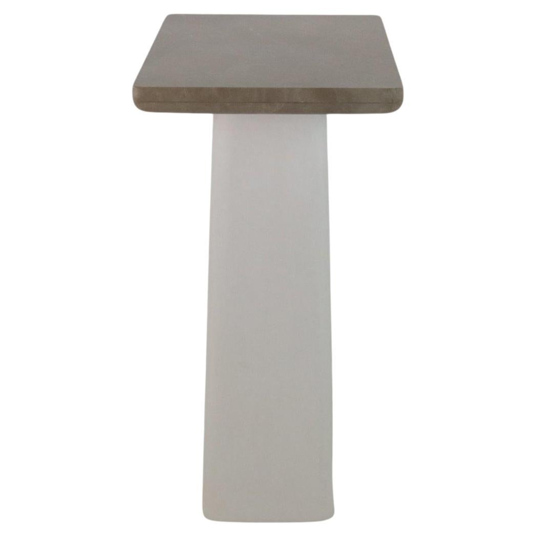 This elegant console features a marble tabletop with veins of brown, cream, and gold. The tabletop rests on two organic-shaped, creamy white plaster legs with a slightly textured surface. The legs curve inwards at the bottom, adding a touch of