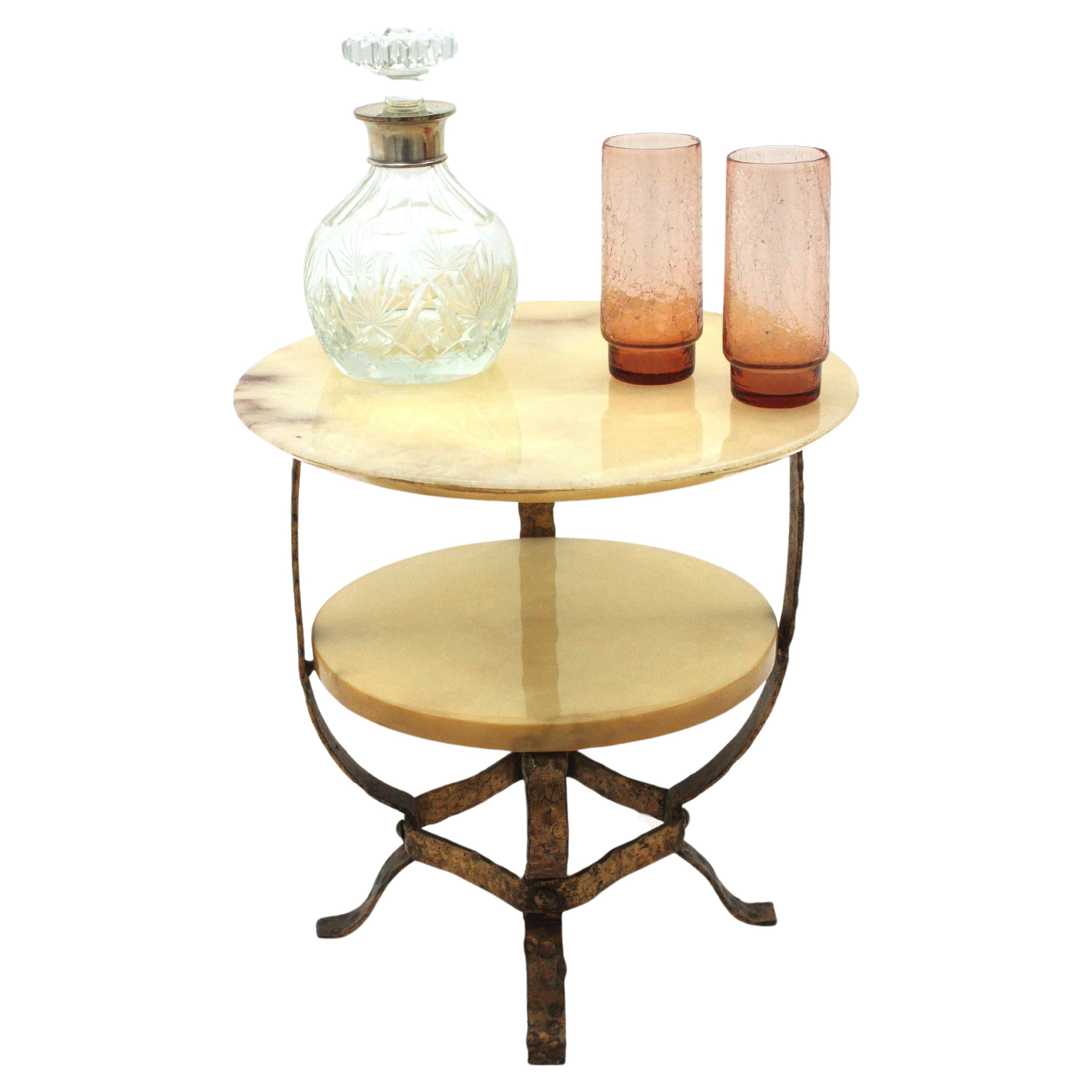 Mid-Century Modern Round Coffee Table or Side Table, Alabaster, Gilt Iron.  Spain, 1950s.
Eye-catching wrought iron low table with two levels in alabaster and hammered gilt iron base. 
An interesting combination of materials is used to create this
