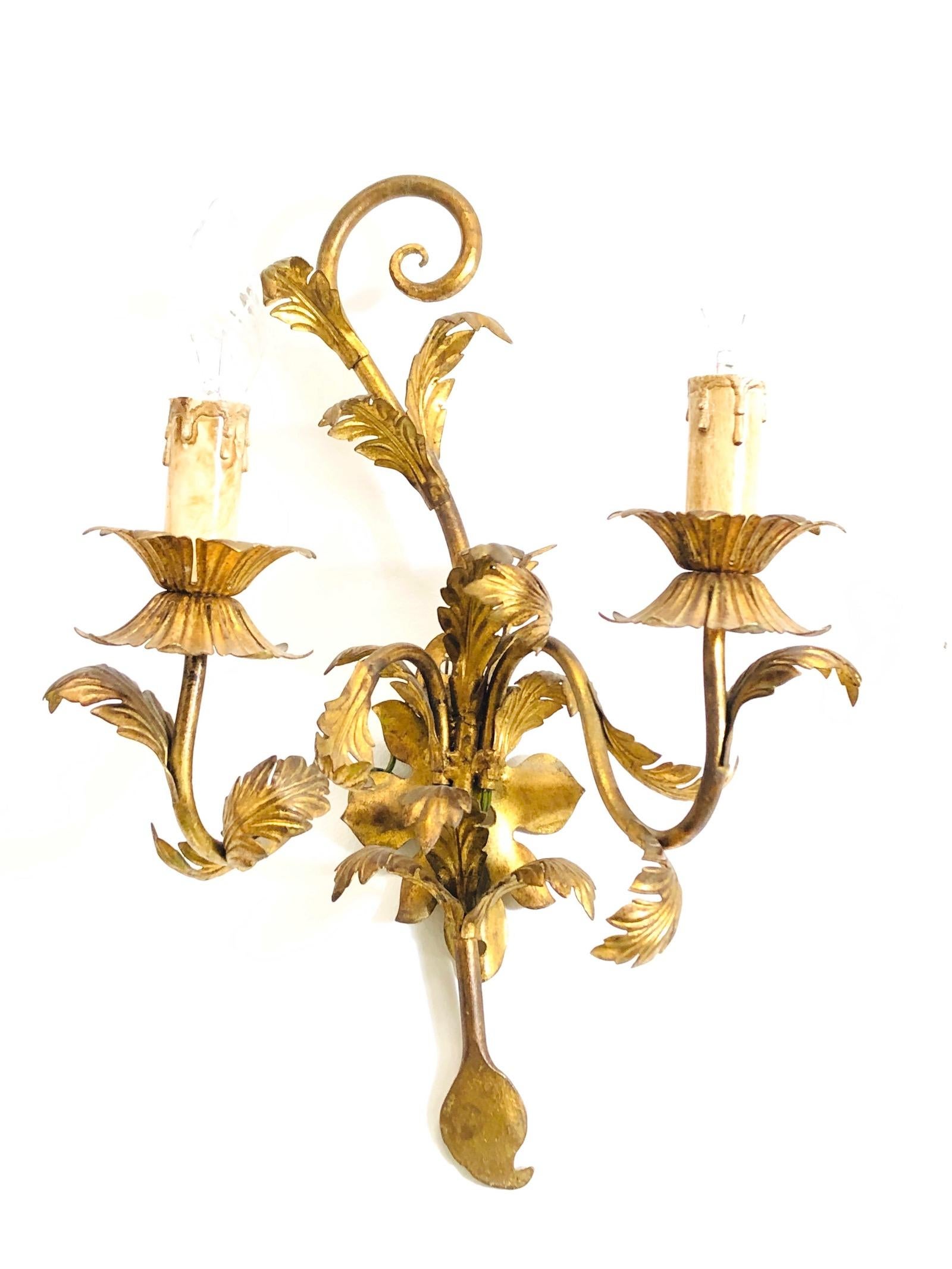 A pair Hollywood Regency midcentury gilt floral tole sconces, each fixture requires two European E14 candelabra bulbs, each bulb up to 40 watts. The wall lights have a beautiful patina and give each room a eclectic statement. Made by Koegel Leuchten