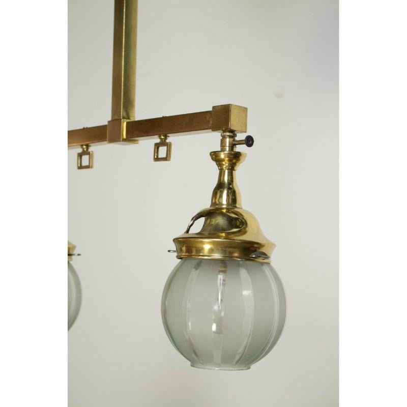 Small two light gas fixture. Squared Tubing in the Mission style. Brass with original Welsbach Mantle burners, that have been electrified. original glass shades with clear and frosted vertical stripes. C. 1880.


