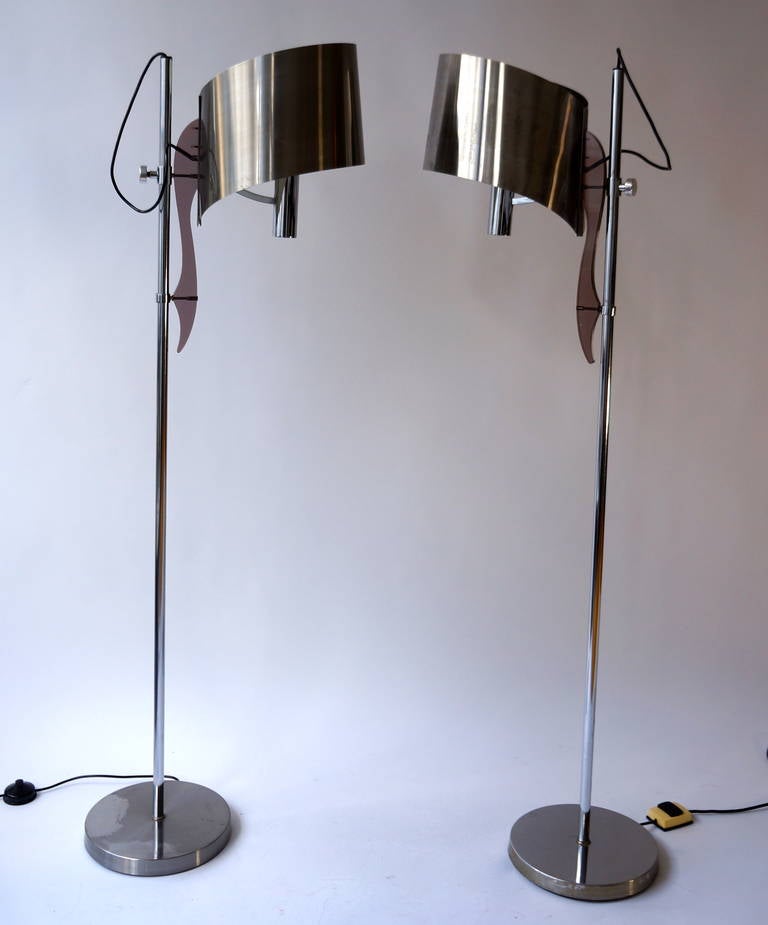 Very nice floor lamps by Maison Charles with adjustable shade. This typical design by Maison Charles has a very nice brown perspex detail and the stainless steel shade is adjustable in height. The brushed aluminum shade has an organic shape and some