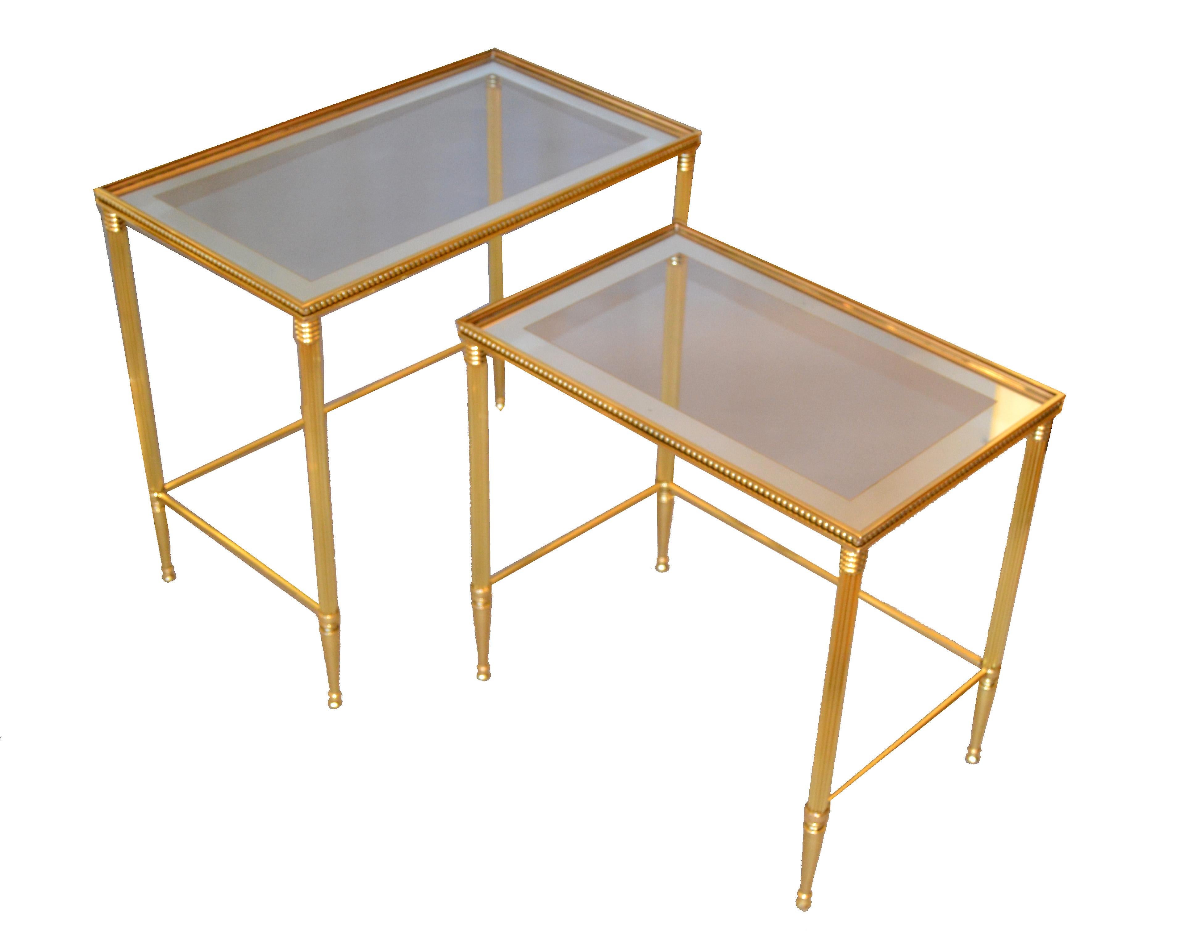 Two of Maison Jansen brass nesting tables with mirrored edge glass tops.

Size of each table:
23.25