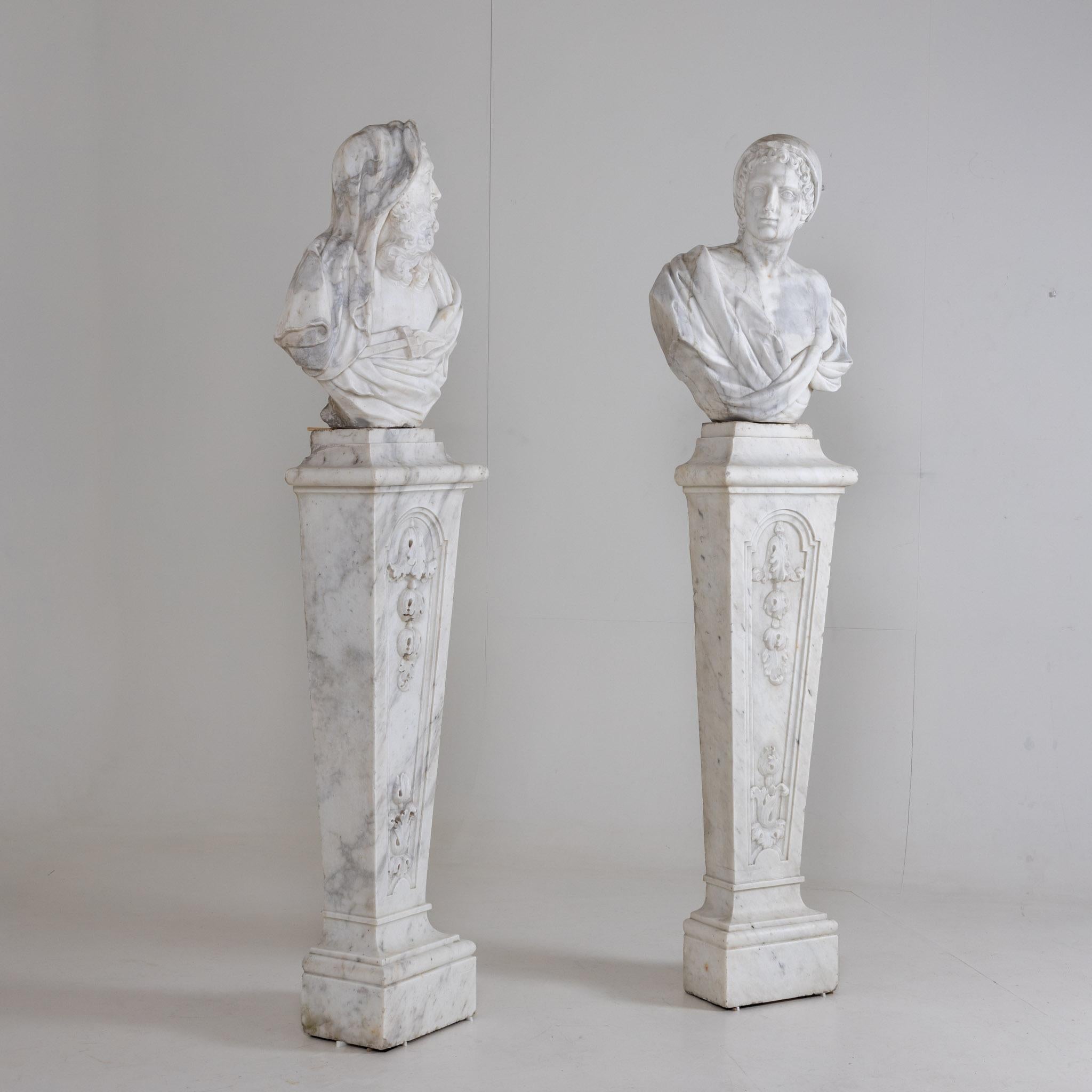 Two life-size, expressive busts of white marble as allegories of winter as an old man with coat and tongs - and - of spring as a youth with cap, on conical stelae with leaf ornaments.
Provenance: formerly in the courtyard of the Merode-Houffalice