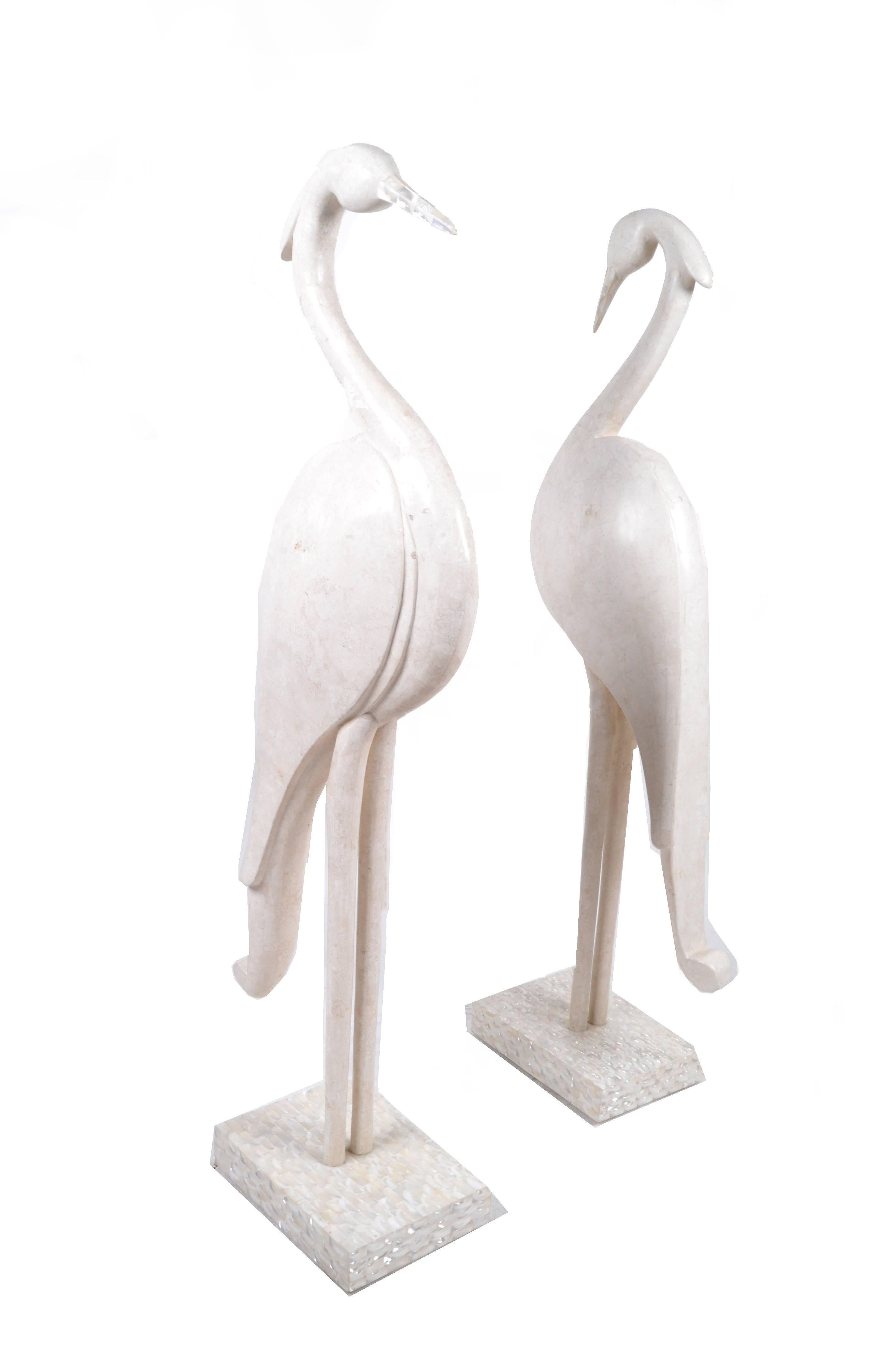 Elegant pair of birds in white ivory stone with beige fossil stone mounted on a square base.
The beaks as well as the bases are in mother-of-pearl.
Makers mark underneath, Marquis Collection of Beverly Hills.
In good vintage condition with normal