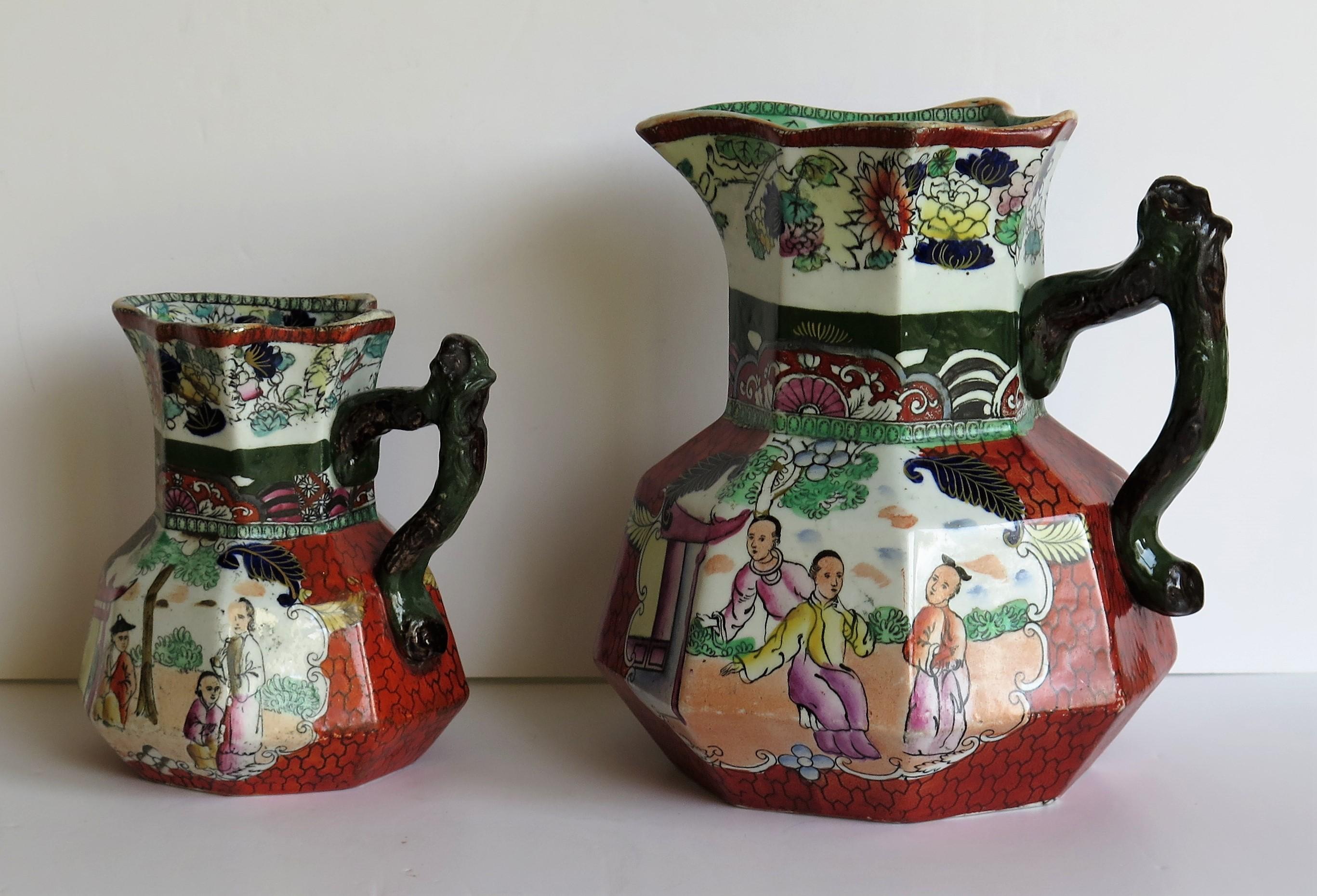 This is two very good Hydra Jugs or pitchers with the rarer branch handles, in the Red Scale Conversation Group Pattern by Mason's Ironstone, England, dating to the second quarter of the 19th century, circa 1835. 

The jugs are very decorative and