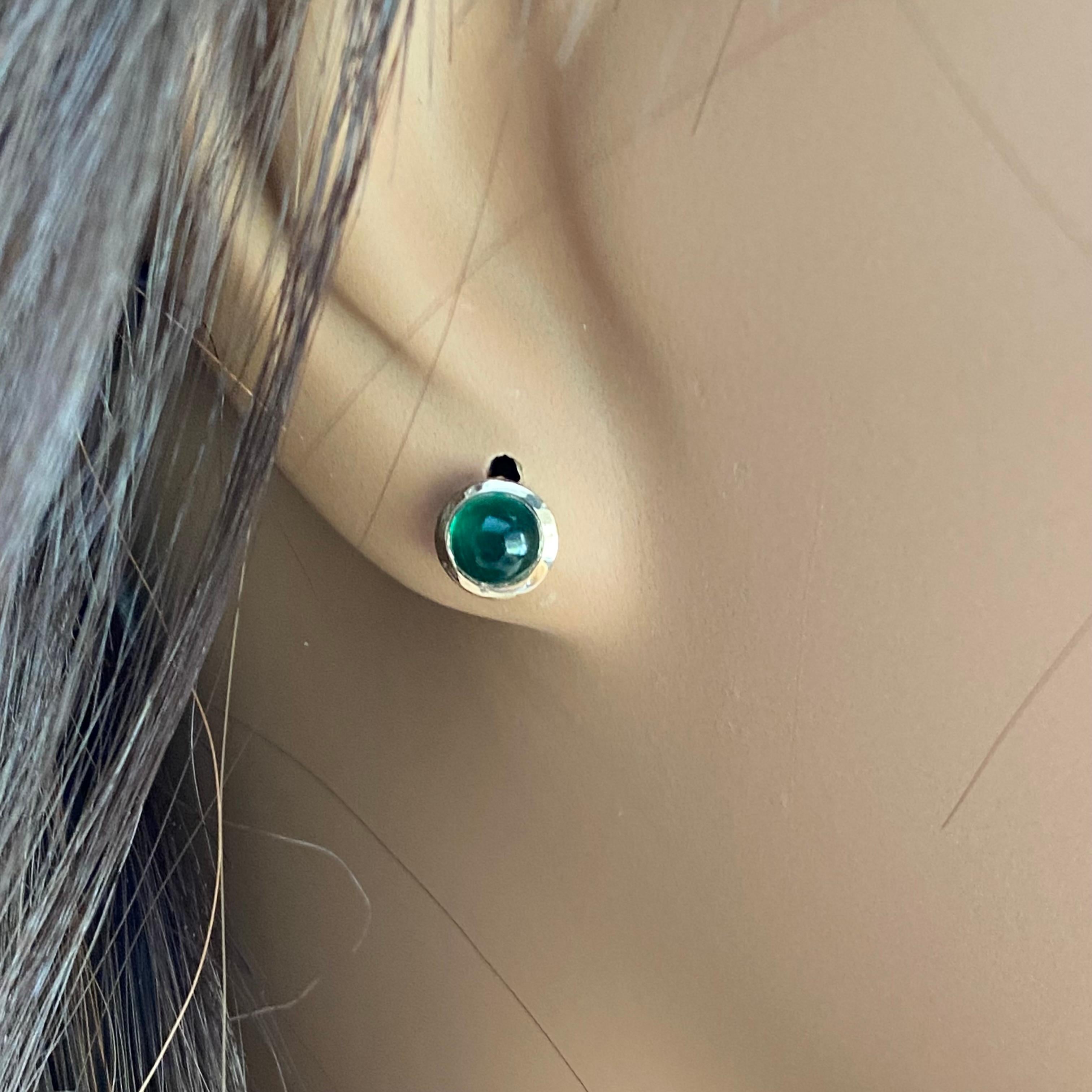14 karat yellow gold bezel-set cabochon emeralds stud earrings 
Two perfectly matched round emeralds weighing 2 carats
Width of the earrings 0.23 inch in diameter 
New Earrings
Handmade in USA
Friction push backs are included
The two matched