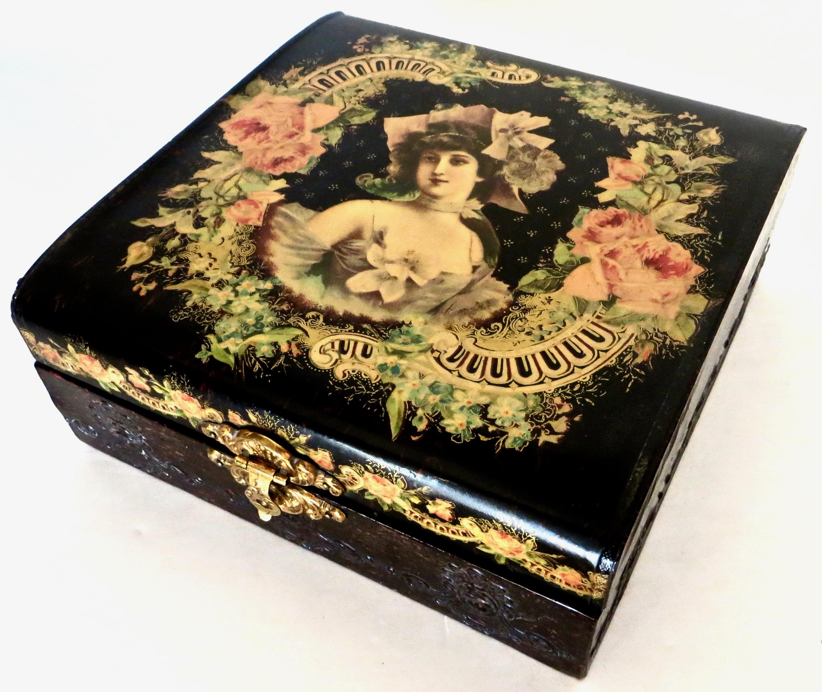 From the same estate come two American, late 19th century matching Victorian celluloid boxes; typical of that era, they are highly decorated. The top of the jewelry box shows a pretty young lady; incorporating a floral motif with pink roses and a