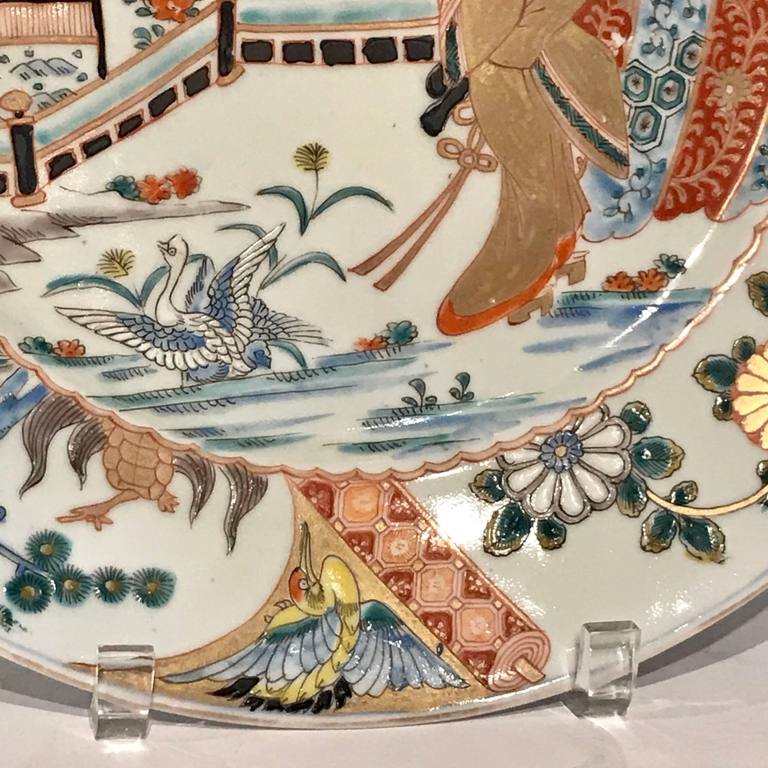 Two Meiji Imari chargers with court decoration, each one finely decorated of a lady of the court in landscape.