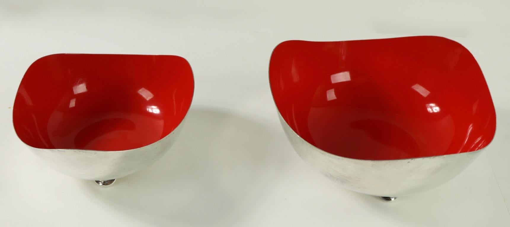 Two freeform midcentury silver pate bowls with lipstick red enamel interior. Both are signed on the bottom, both are in very fine original condition, matching form, one is larger 9.25 diameter x 4.75 smaller bowl 7.5 diameter x 3.5 inches. Offered