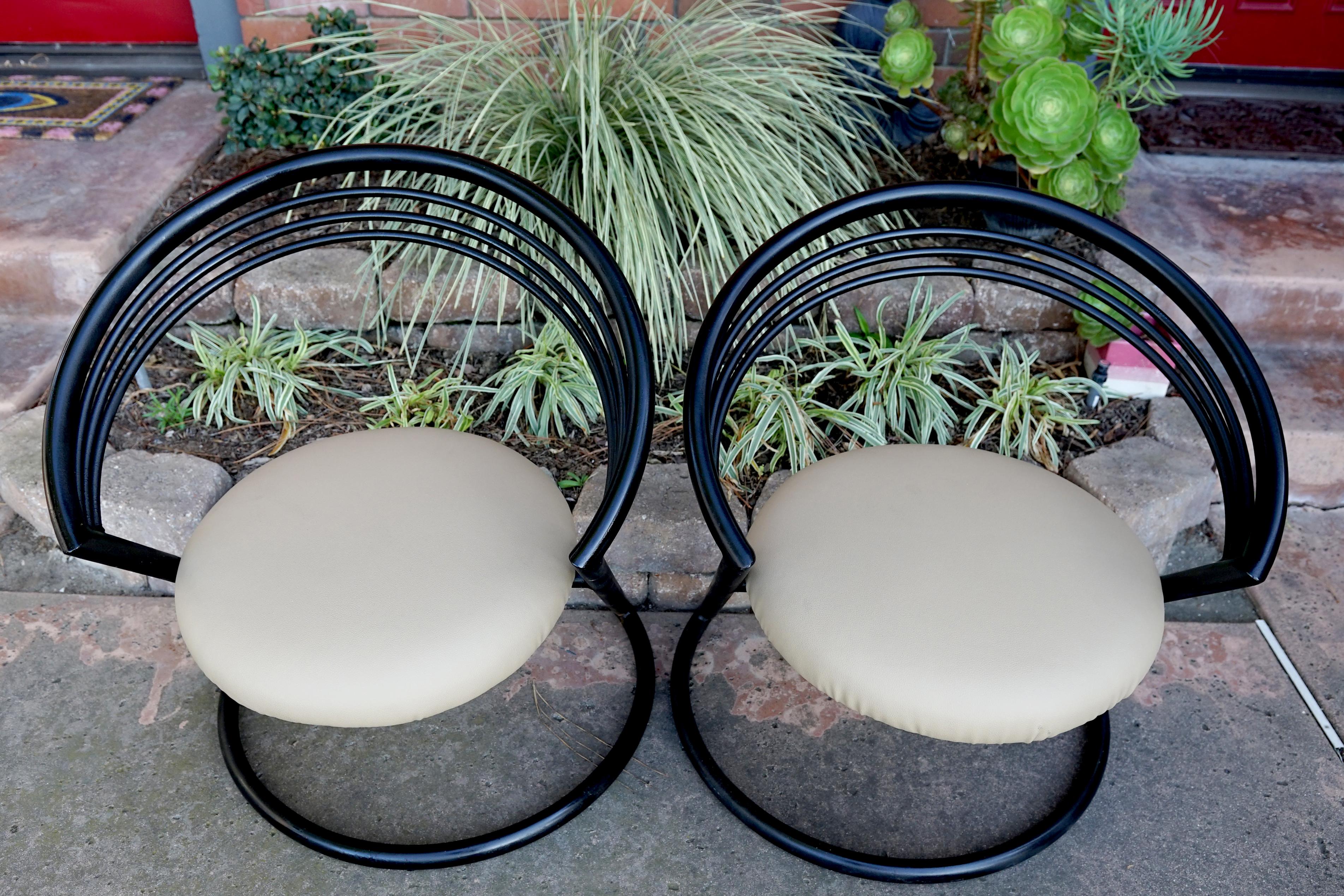 This pair of chairs epitomizes space age design and the atomic era. They are influenced by Thonet's cantilever chair, and they are also reminiscent of the Marc Sabot--Willy Rizzo form. 
In ebonized iron, they are mid 20th century, produced in