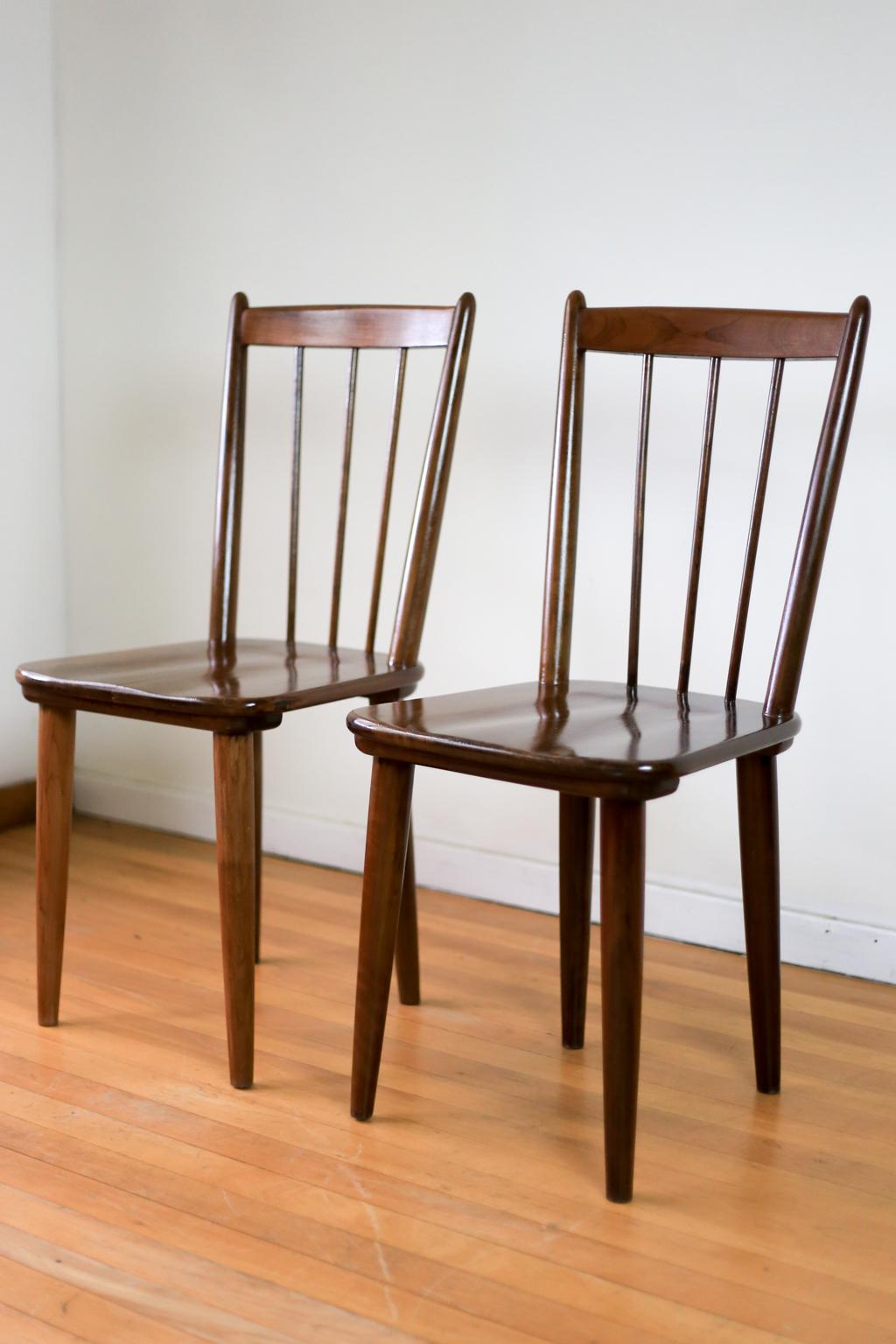 A pair of Mid-Century Modern, straight back, imbuia dining chairs by renowned South African furniture designer, E.E. Meyer. Meyer called this design the 