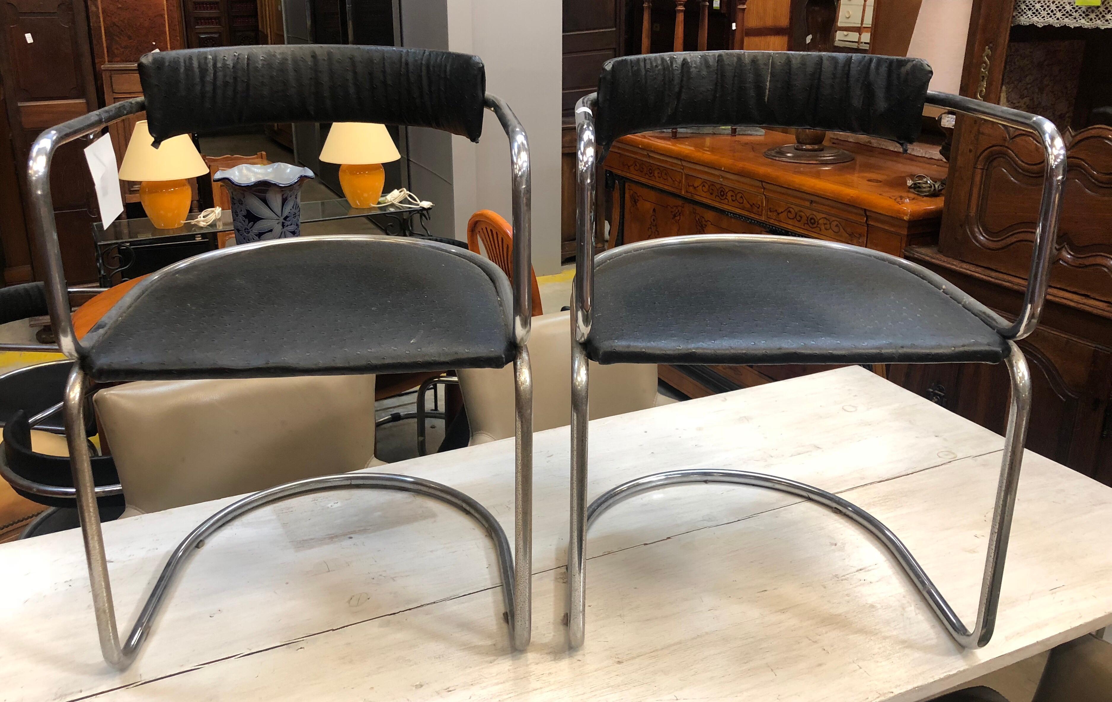 Pair of Mid-Century Modern chrome black leather skai chairs.