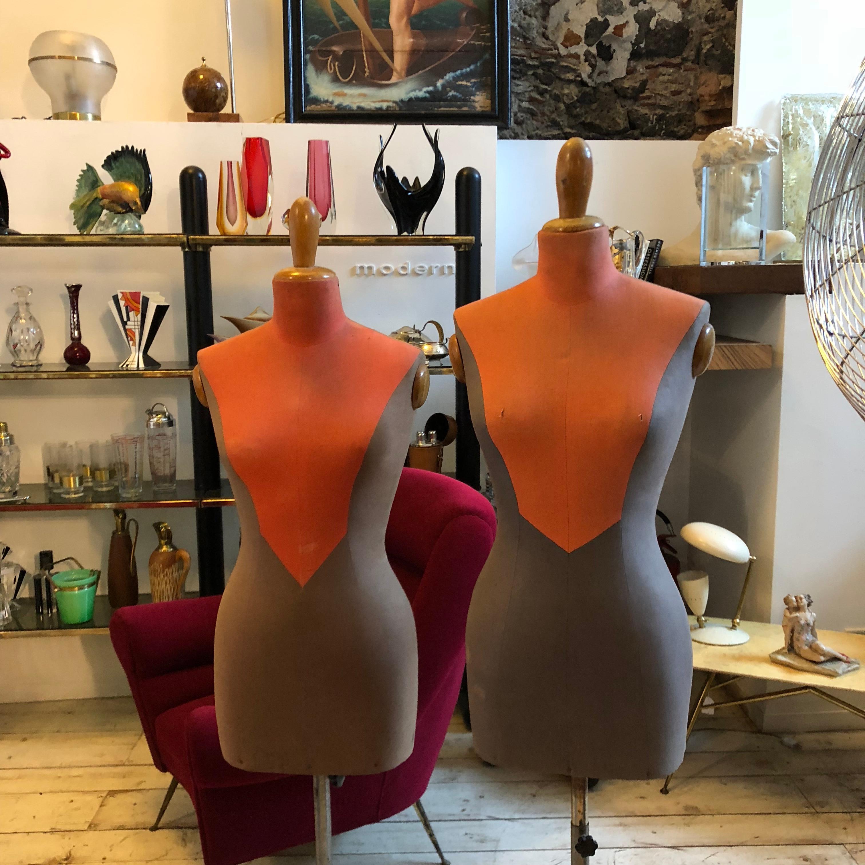 Stylish Mid-Century Modern wood and orange and brown fabric adjustable tailor's mannequin, signs of the time.