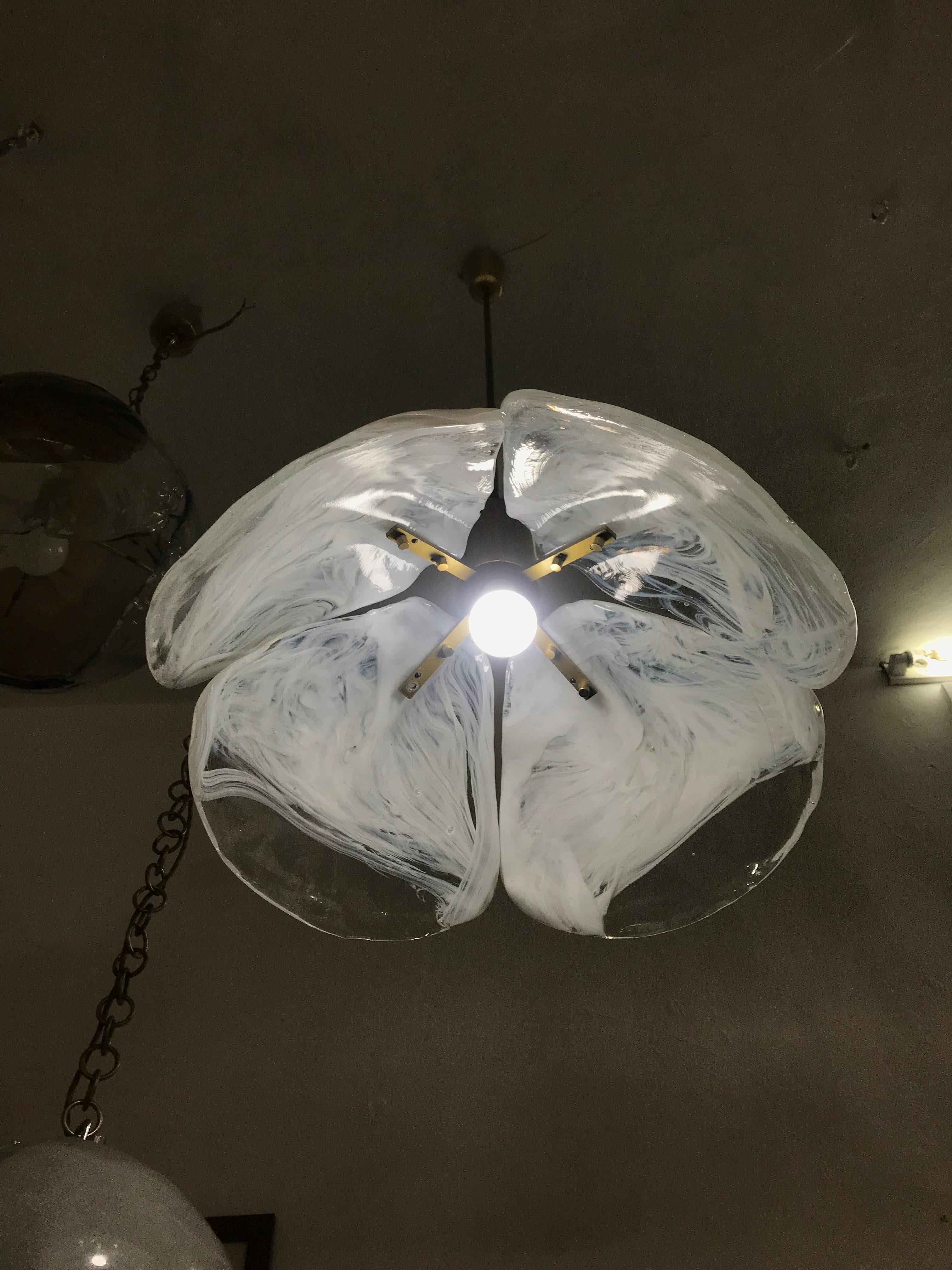 Mid-Century Modern pendant light by Kaiser Leuchten, circa 1970, consisting of 4 ´petals´ in clear and white blown glass and brass hardware, this model is often attributed to Carlo Nason but we can´t confirm this at this point.
There are 2