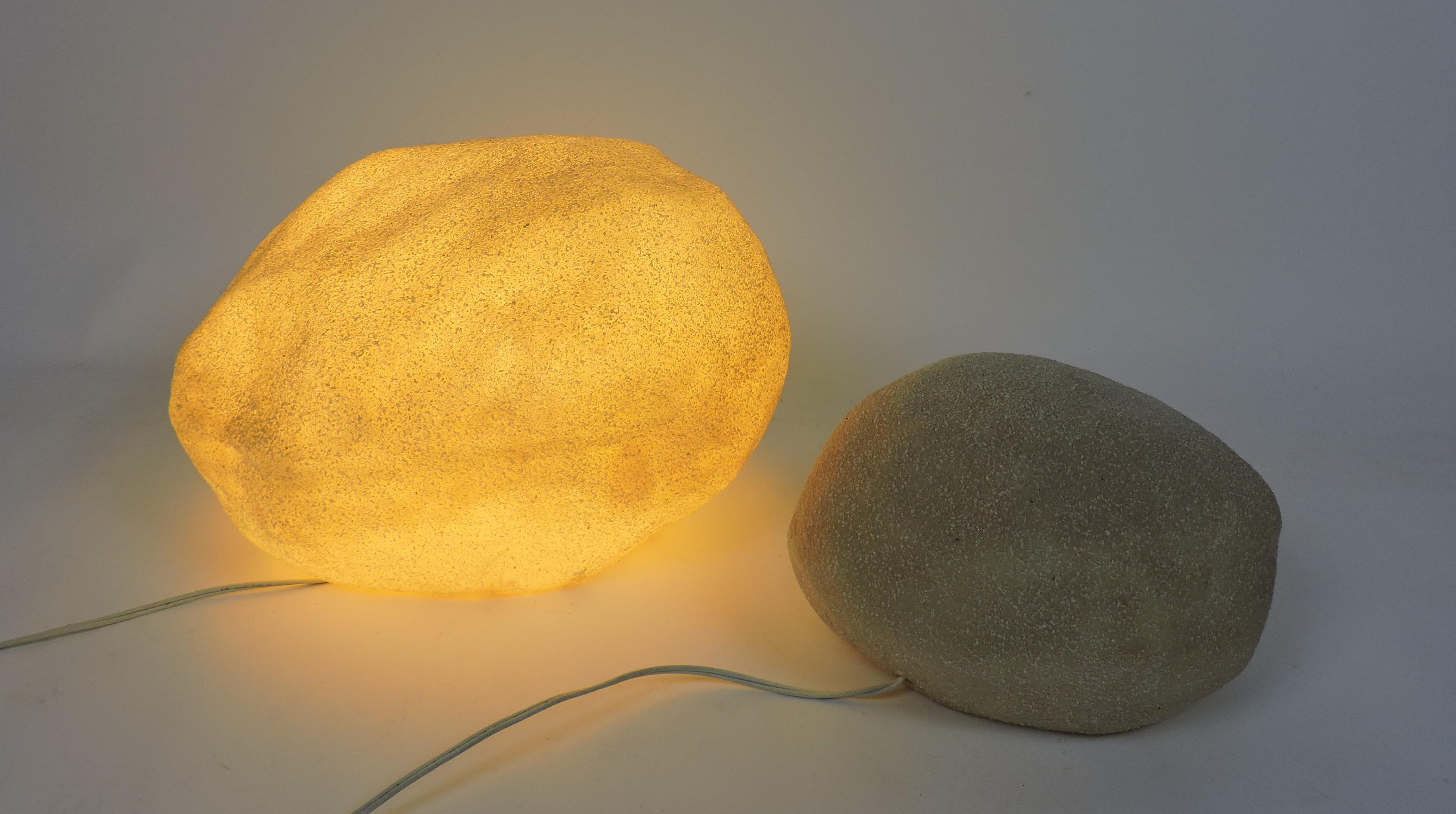 Very cool luminescent set of 2 moon rocks designed by Andre Cazenave and manufactured in Italy by Singleton in the 1970s. These lamps are made of translucent resin with marble powder inclusions and glow with a soft ambient light when lit. The larger