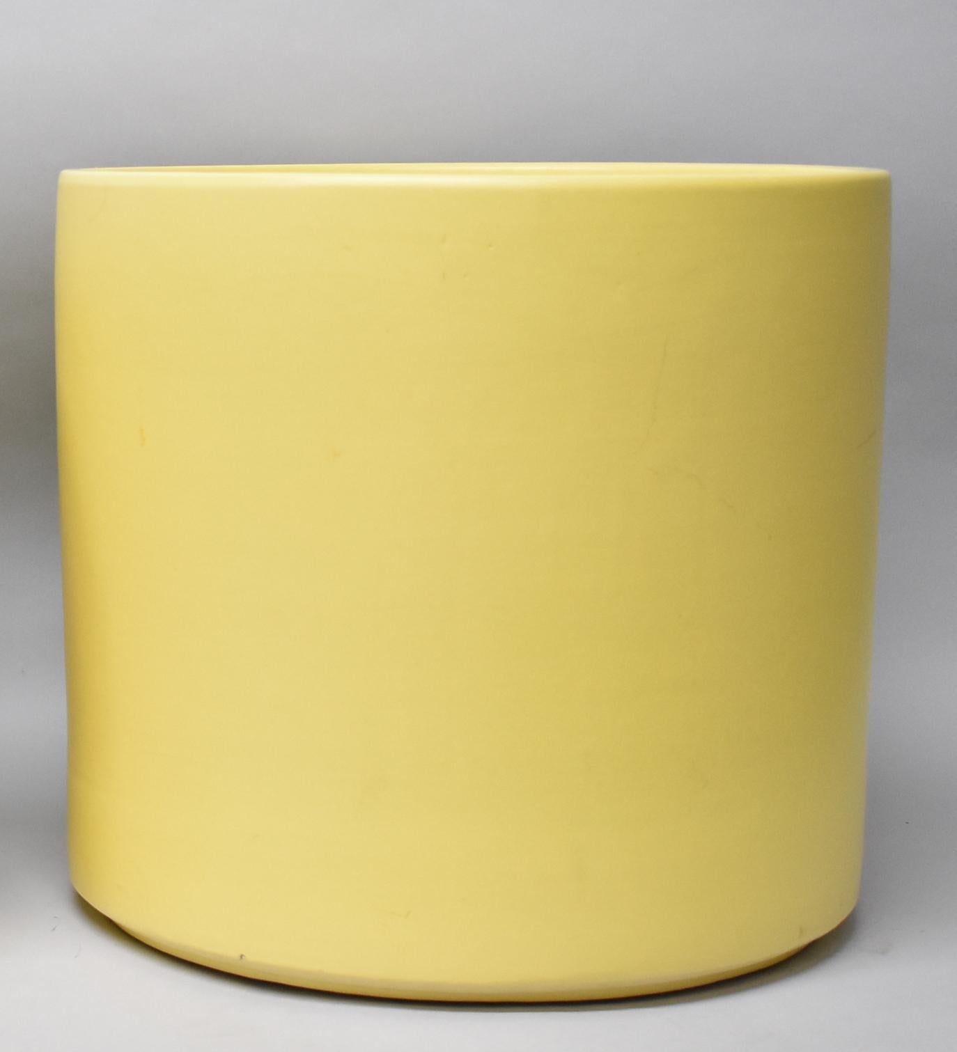 Two large Mid-Century Modern pottery planters in yellow by Gainey Pottery, USA. Light crazing interior bottom of one. Two flea bites on bottom edge of one pot. Measures: 15.25
