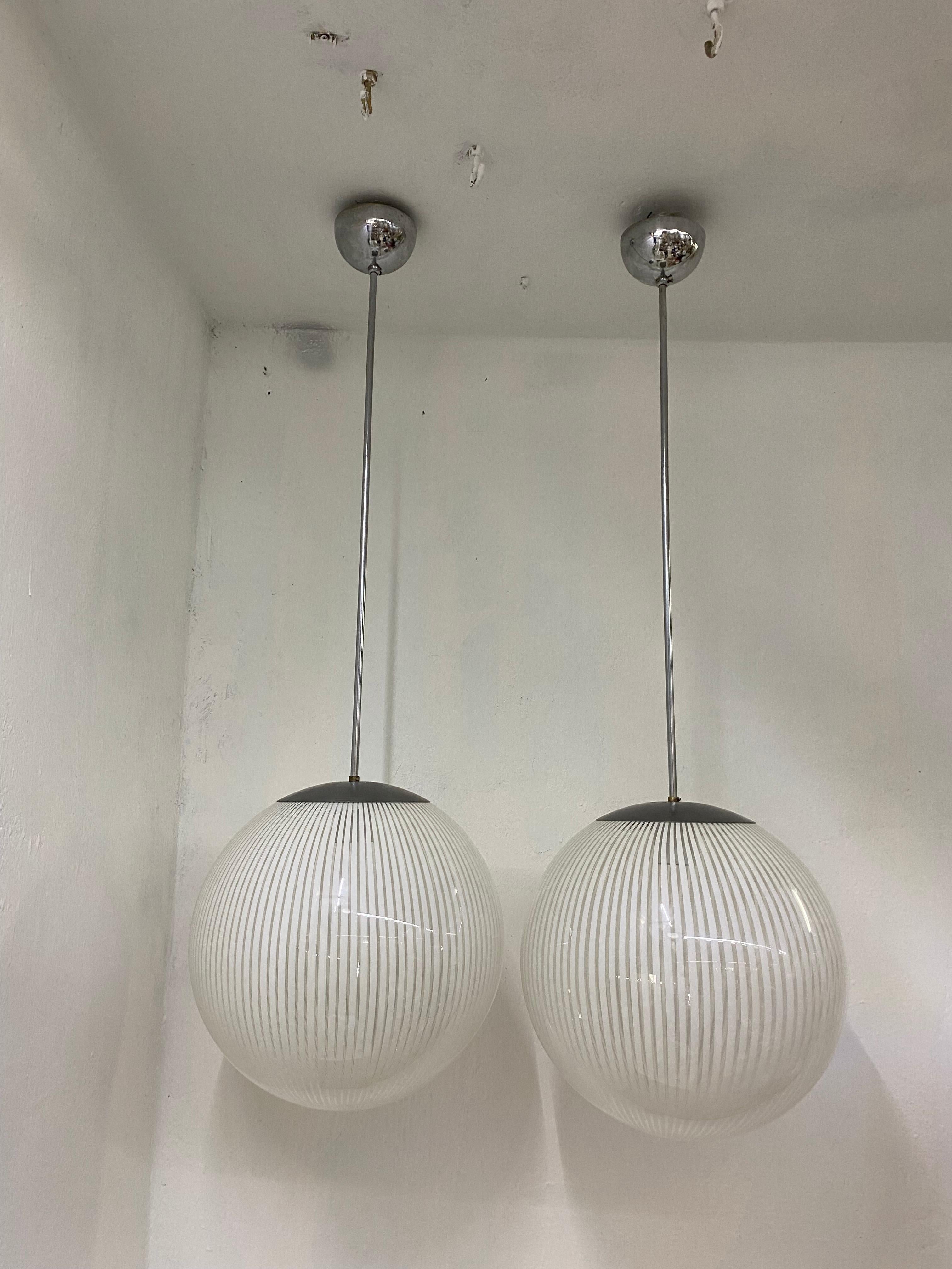 Two beautiful and large Mid-Century Modern pendant lights in white and clear hand blown Murano Glass in the 