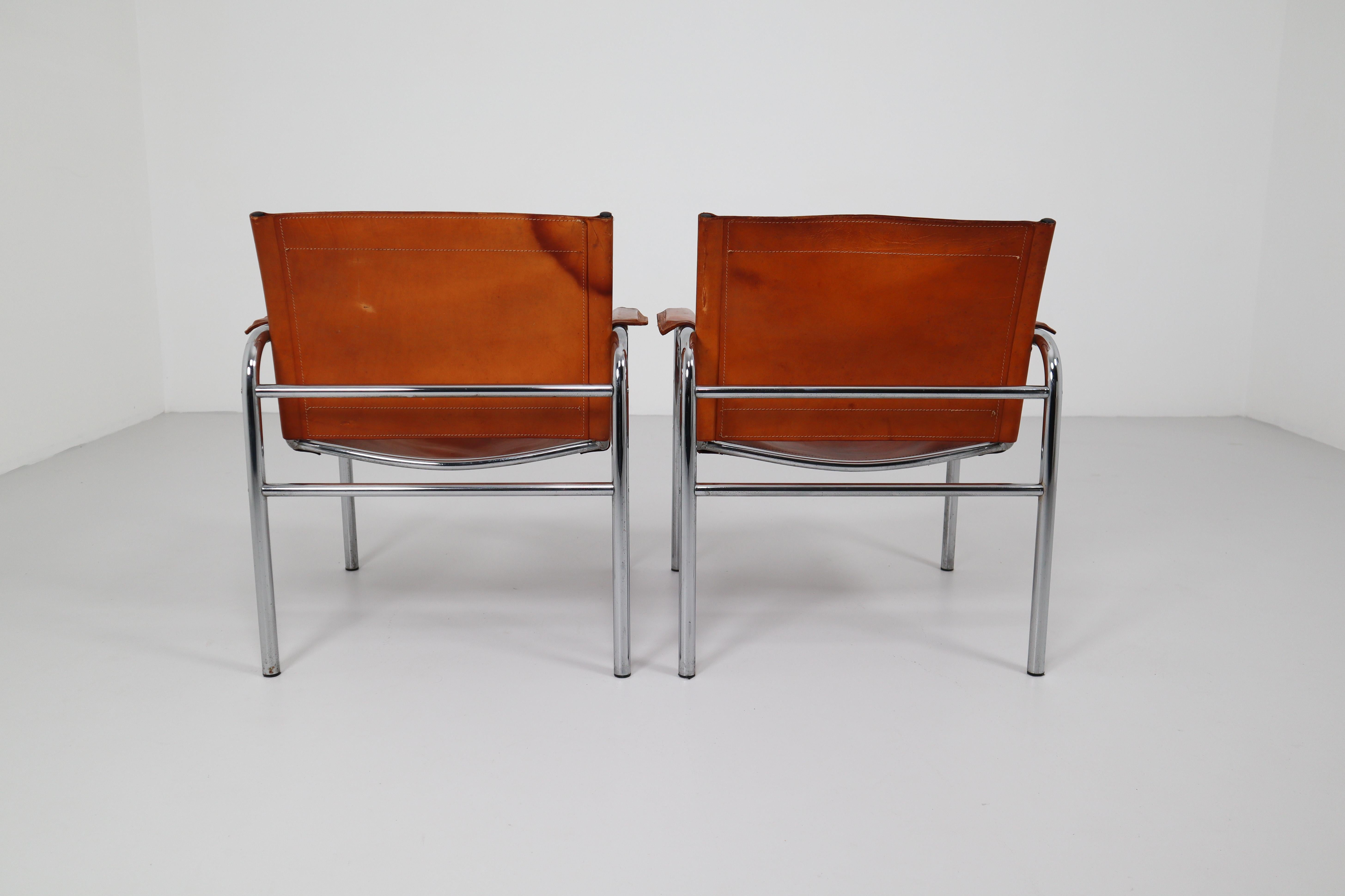 French Two Midcentury Tubular Armchairs in Patinated Cognac Leather, France, 1960s