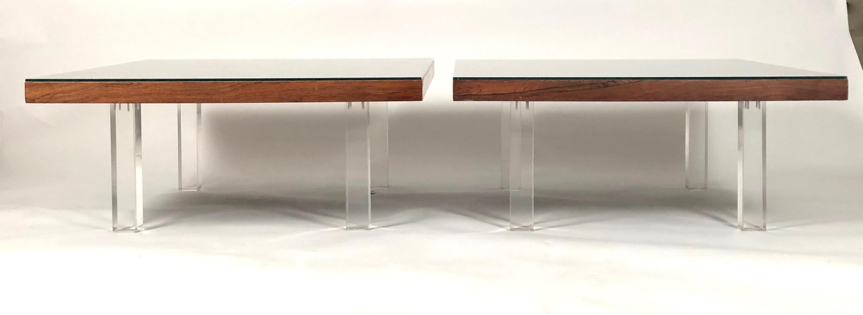 Two Milo Baughman rosewood and Lucite coffee tables, the square tops with richly figured book-matched rosewood veneer over four square section solid Lucite legs, retaining the original manufacturer's labels, with 1967 date of production, on the