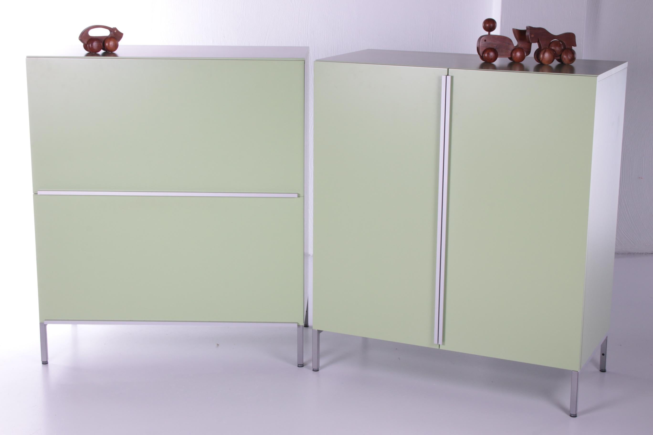 Two mint green Pastoe wall cabinets beautiful timeless design 1980


These are two mint green wall cabinets.

1 cupboard has two doors that open.

The other has two drawers with two more drawers and storage space.

The handles are made of