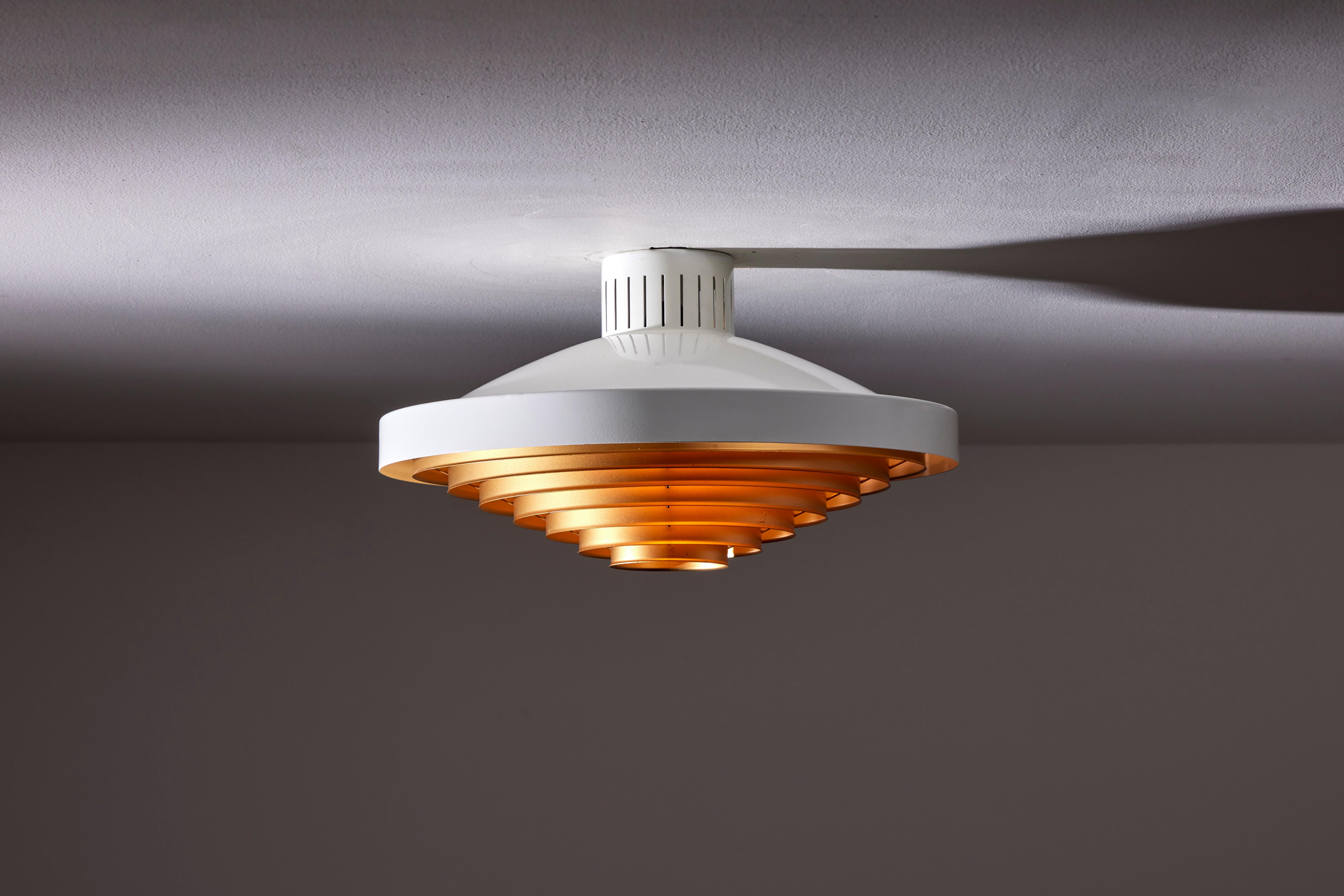 Two model 5560/Z200 flush mount ceiling lights by Lisa Johansson-Pape for Orno. Designed and manufactured in Finland, circa 1960's. Enameled metal, brass. Rewired for U.S. standards. We recommend one E27 60W maximum bulbs. Bulbs not included. Priced