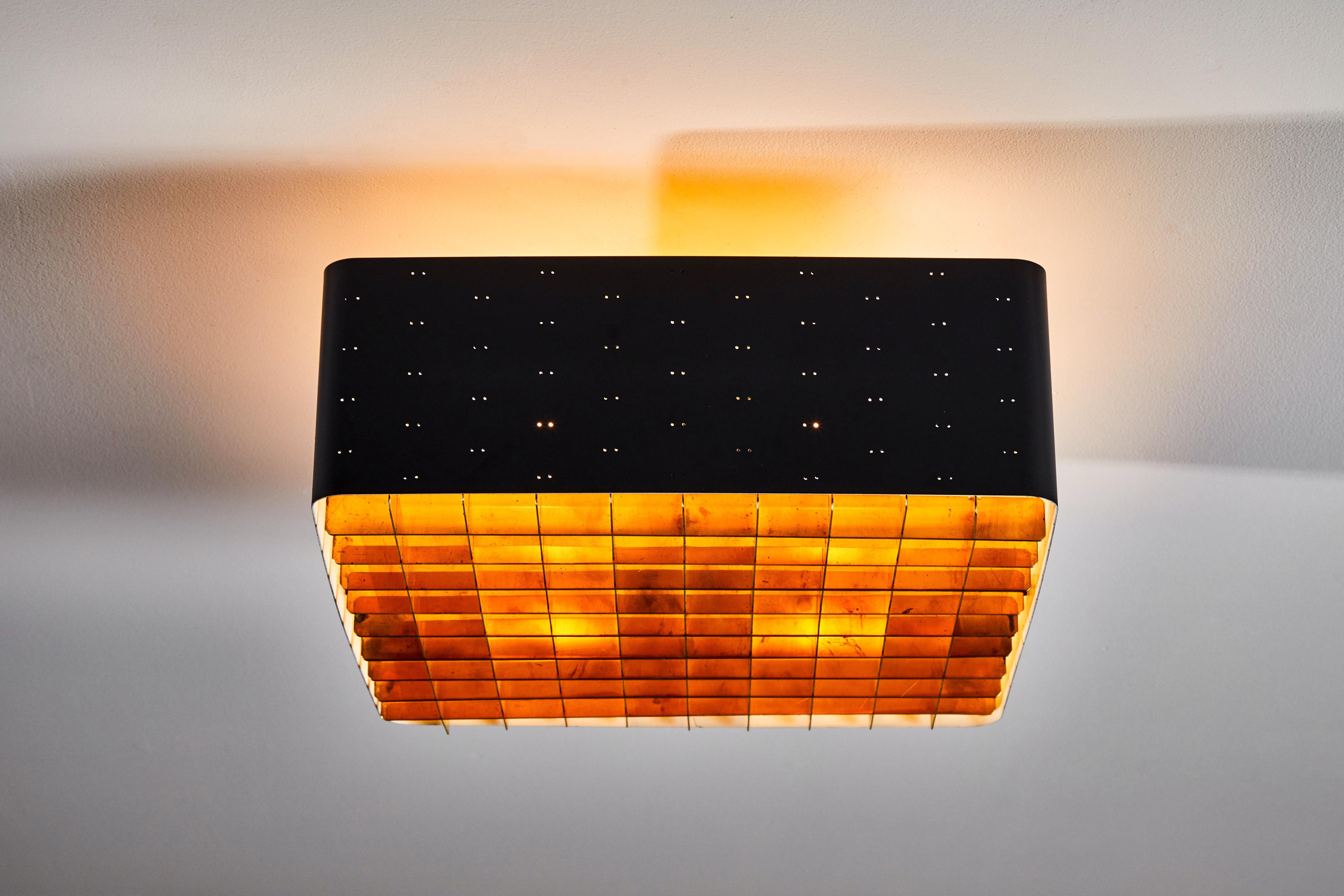 SIngle model 9068 starry sky flush mount ceiling light by Paavo Tynell for Taito Oy. Manufactured in Finland, circa 1950s. Enameled, perforated metal, brass, glass. Rewired for US junction boxes. Takes four E27 40w maximum bulbs.
  