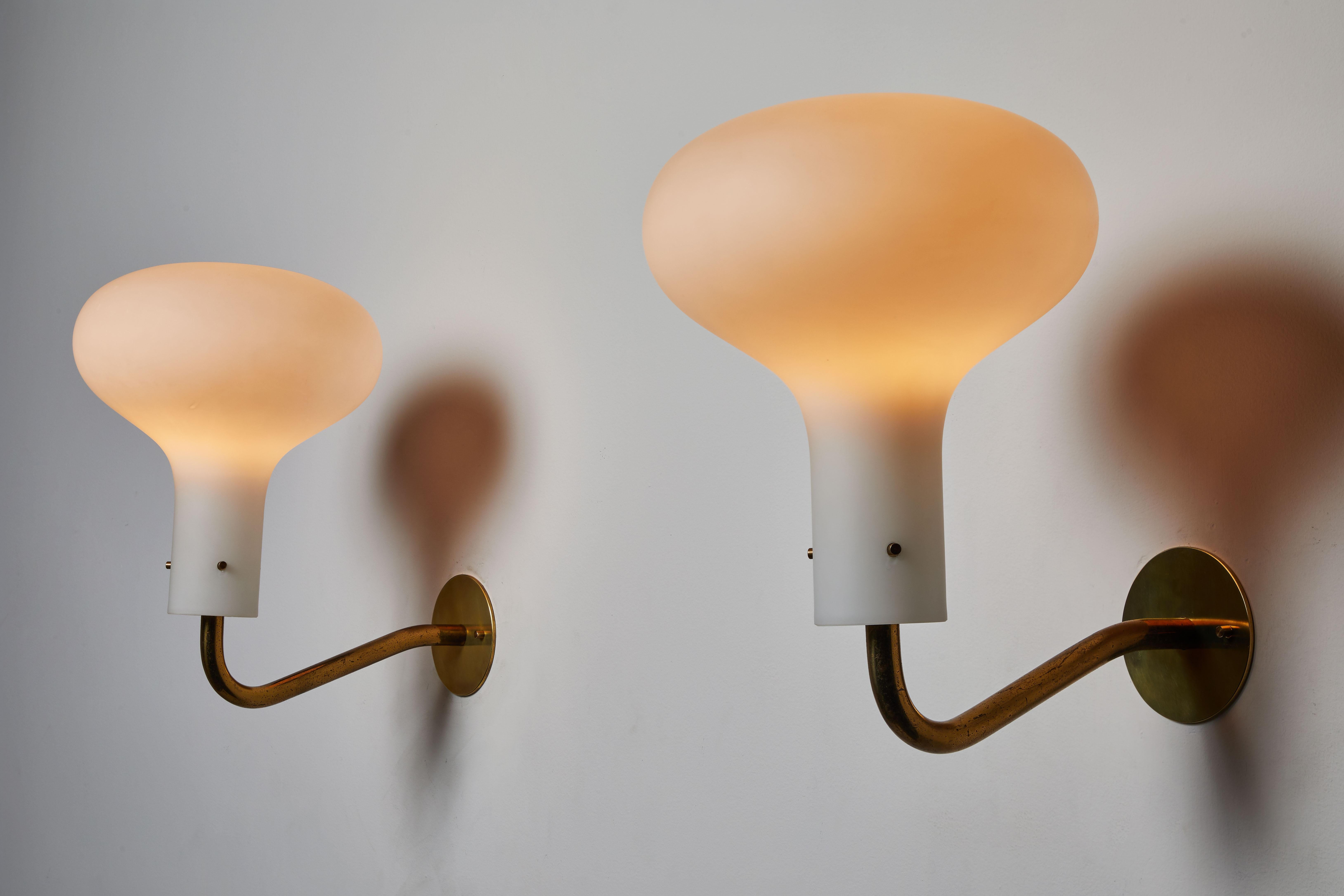 Two model Lp12 Galleria sconces by Ignazio Gardella for Azucena. Designed and manufactured in Italy, 1958. Brass and brushed satin glass diffuser. Rewired for US junction boxes. Each light takes one E27 100w maximum bulb. Priced and sold