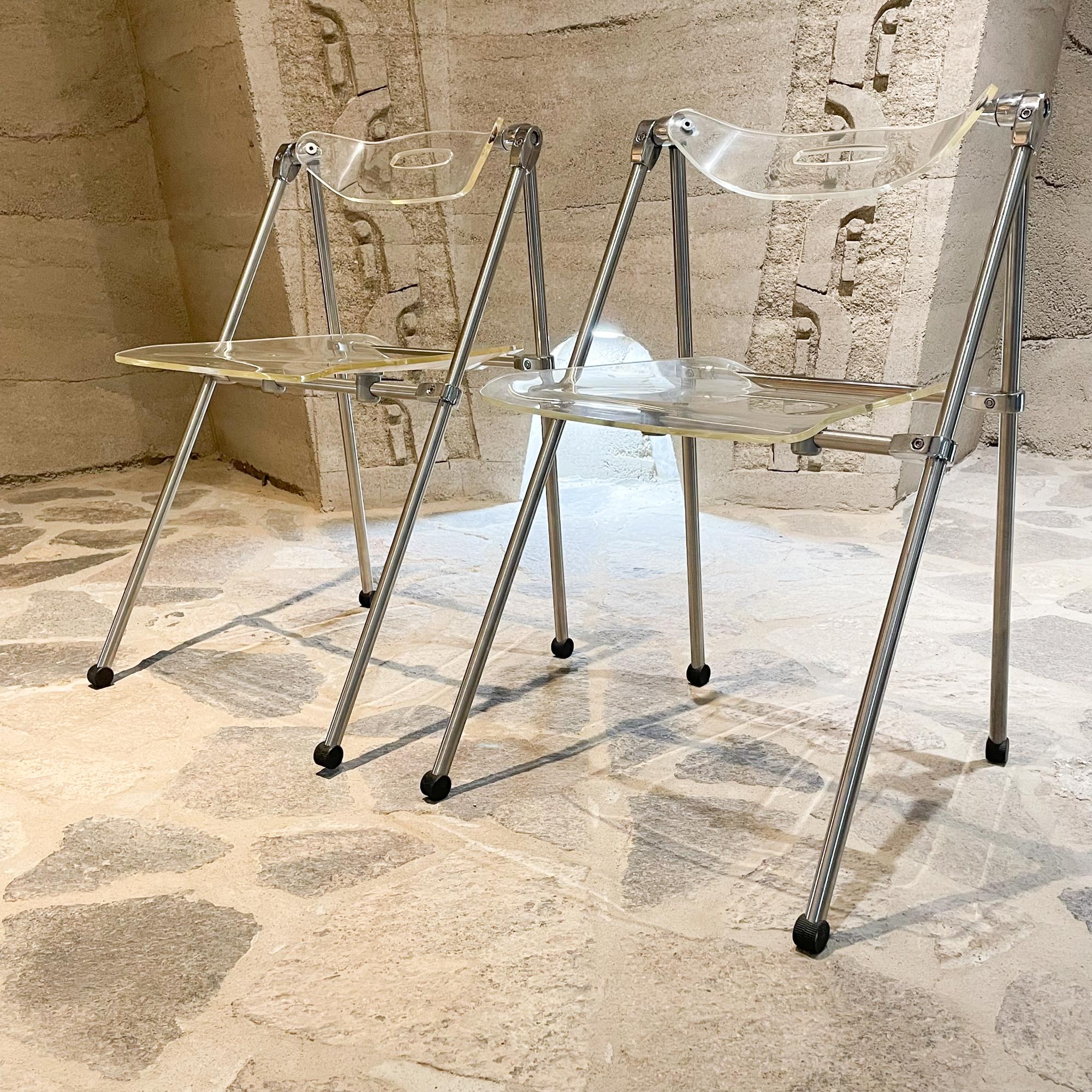 For your consideration: Mid-Century Modern Italy 1960s Pair of Lucite folding chairs 
Style attributed to Giancarlo Piretti for Castelli. Unmarked.
Modern Italian Clean Design.
Original feet caps. Thick clear Lucite. Sleek chrome
