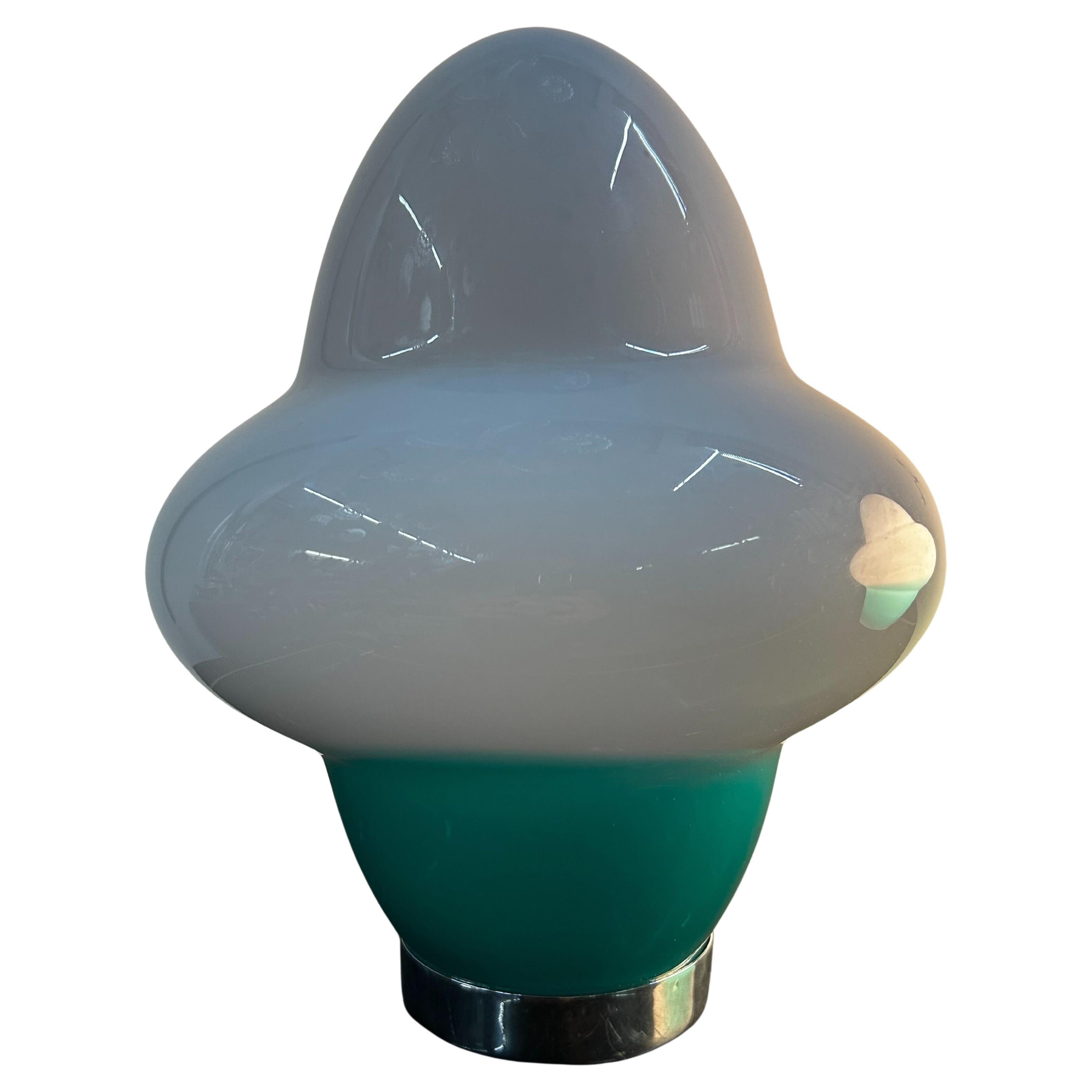 Beautiful table lamp in white and aqua-green hand-blown Murano glass.
Designed by Ettore Sottsass for Venini and manufactured in 1994.
The glass shade is signed 