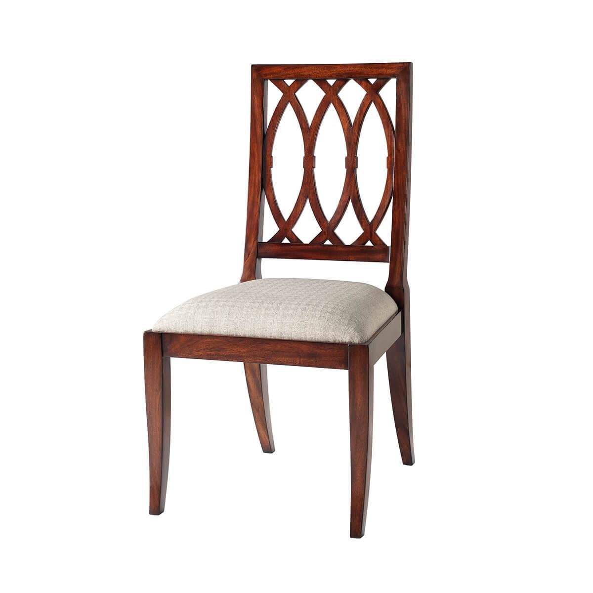 A mahogany lattice back dining chair, the rectangular back enclosing a lattice of interlacing C's above an upholstered drop-in seat, on square tapering legs. Inspired by an Empire original.

Dimensions: 21