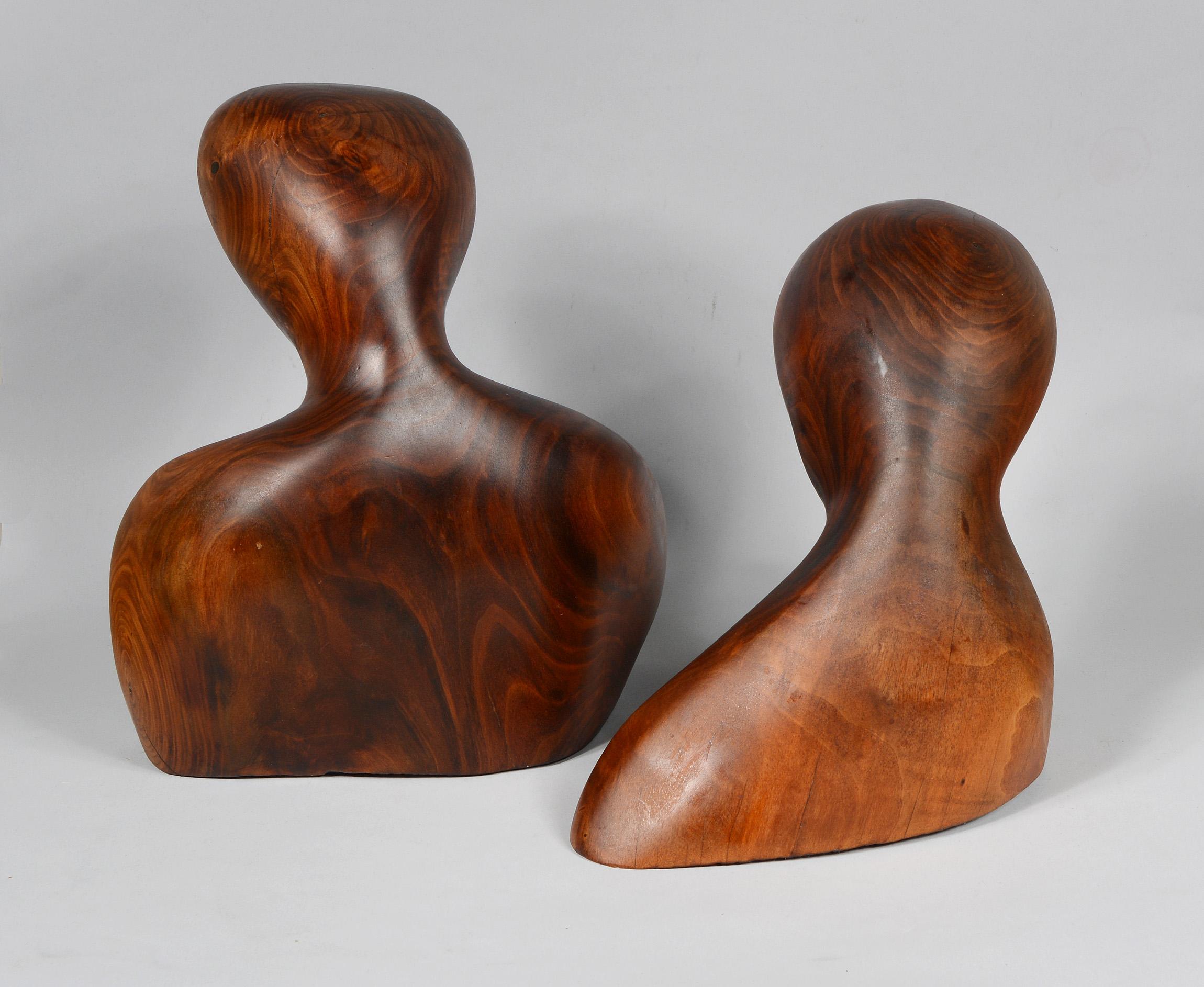 These two abstract modernist busts are carved from solid walnut. These are from a small group of sculptures we acquired by the same anonymous artist. These date to the 1940s-1950s. The larger one has remnants of an exhibition label on the bottom.