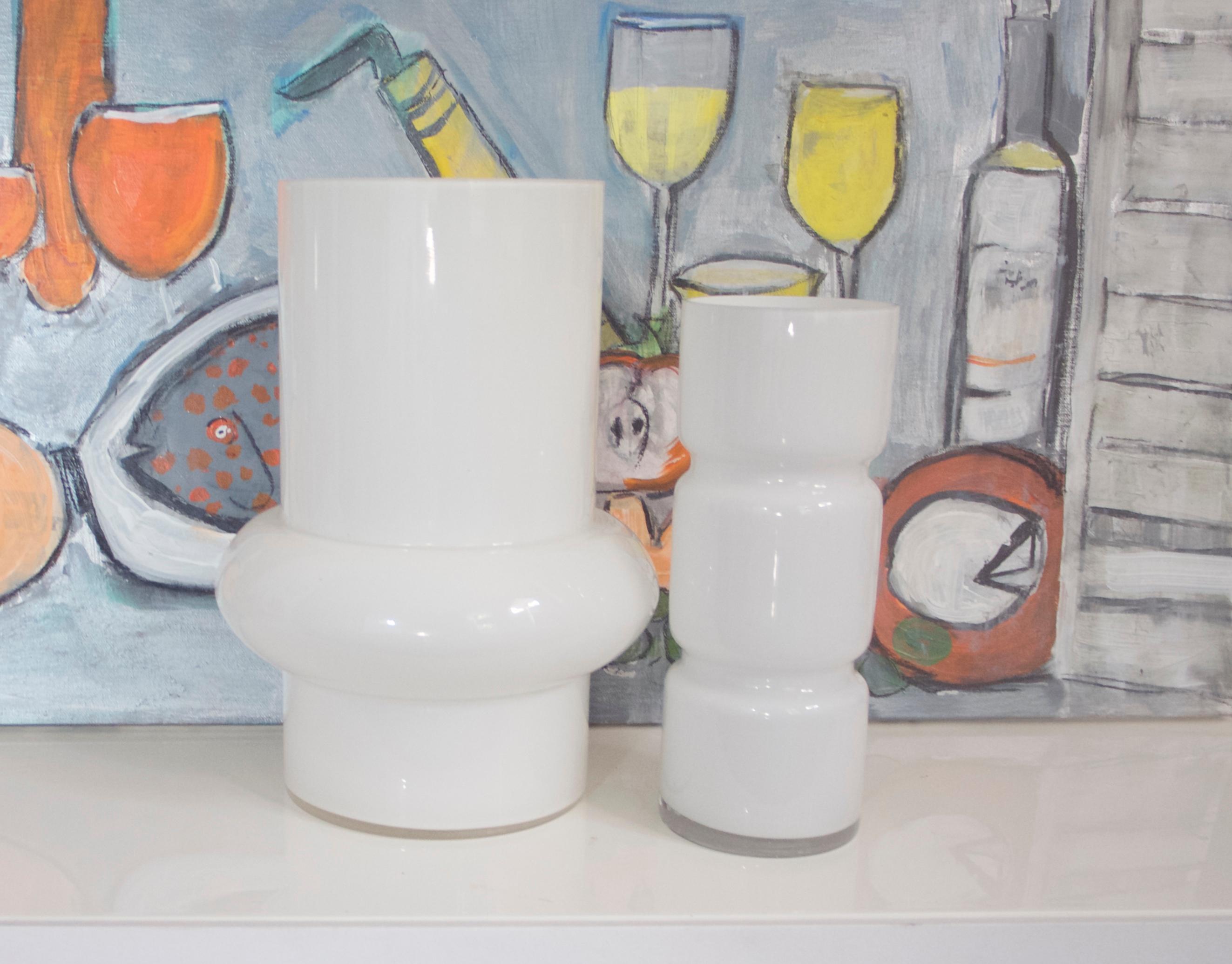 Two modernist Scandinavian Space Age white glass vases from late 1950s-1960s

Large hooped vase - Alsterfors
Measures: Height 32 cms
Diameter 16 cms
Diameter at widest approximately 27 cms
In very good condition commensurate with