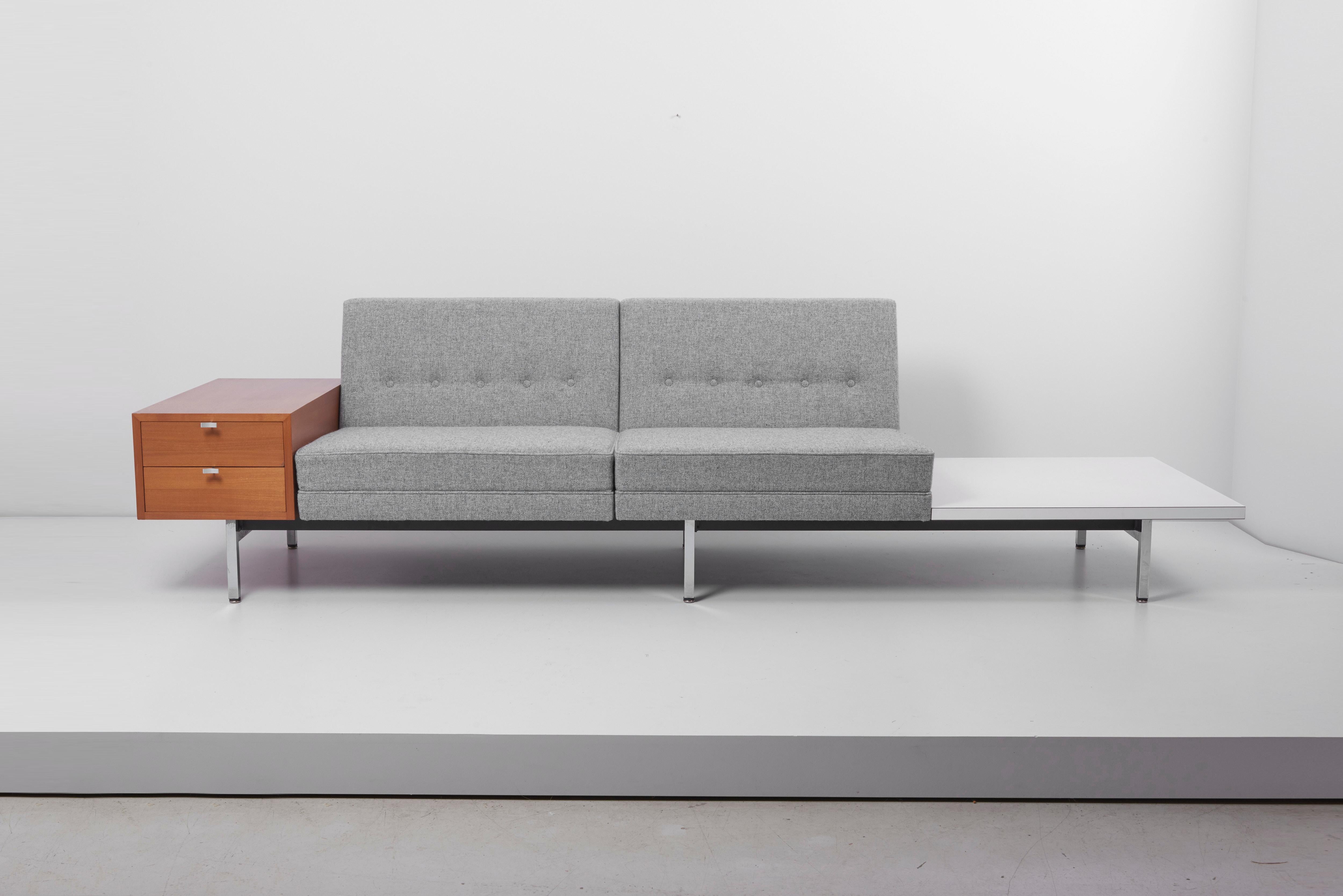 Two bases, six seats in total, a square table and a two-drawer element. All pieces can be placed modular - the name says it all. Newly upholstered in grey Hallingdal fabric by Kvadrat. The sofas shown in the photos are 230 cm and 270 cm long (90.55