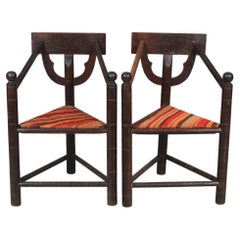 Pair of teak handencraved chairs with three legs. Monk chairs. 