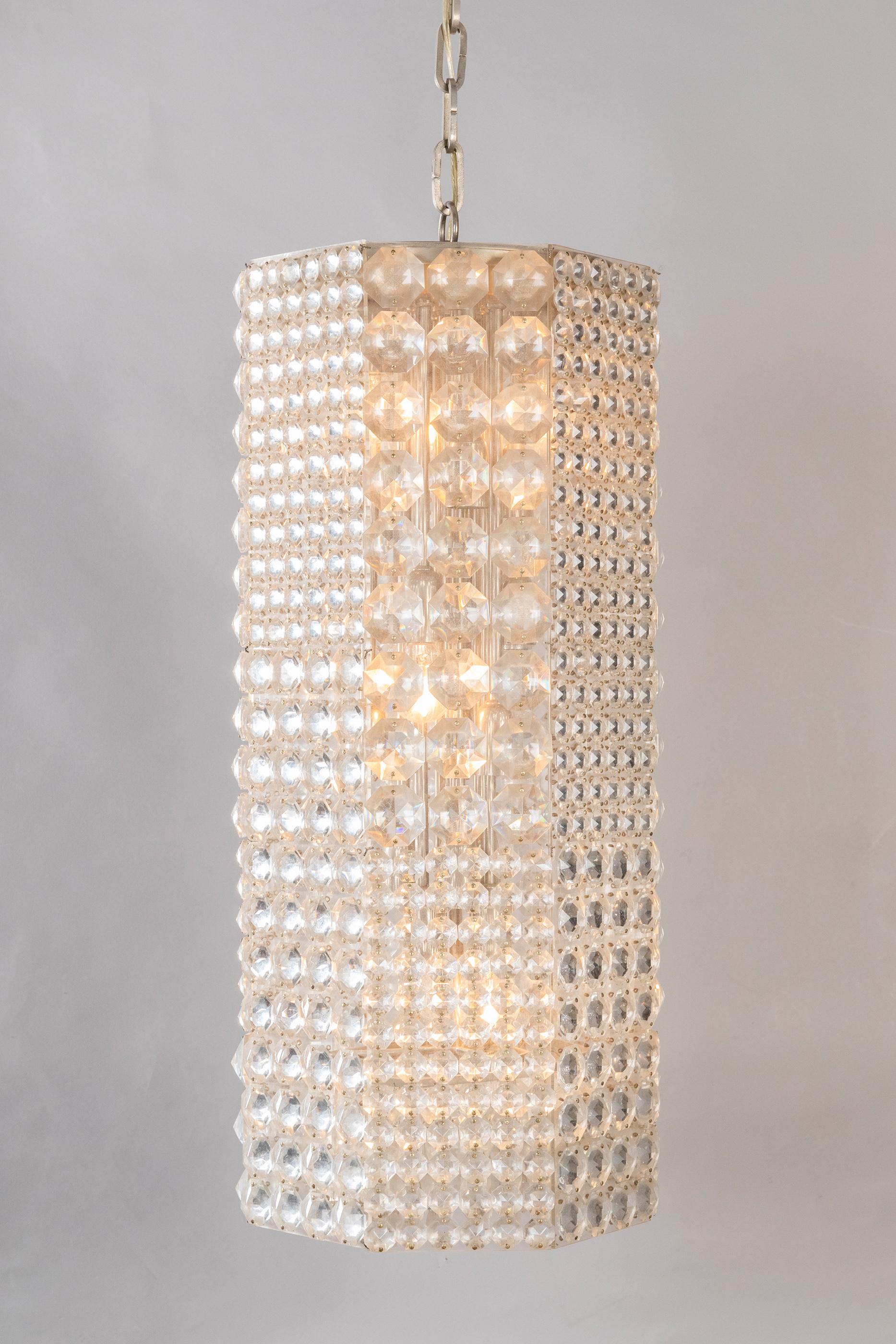 These two falling lights will sparkle and give glamour to the room: Pieces of Jewels made of faceted crystal elements fitted on Lucite structure .Very impressive length: 150cm with the chain and 65cm without. Oswald Haerdtl, Austrian designer has