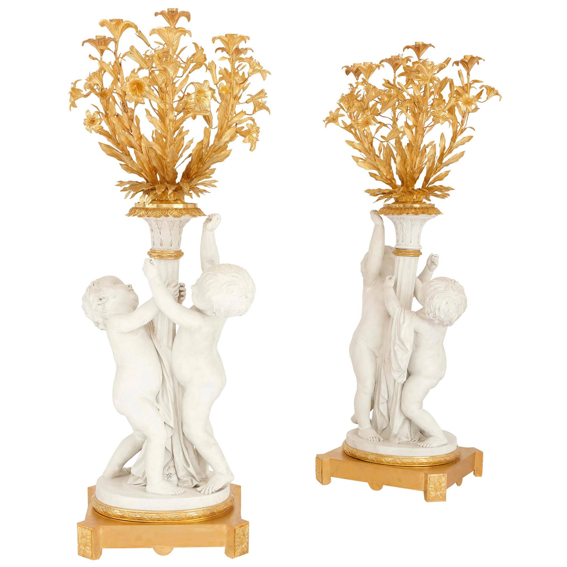 Two Monumental Biscuit Porcelain and Gilt Bronze Candelabra For Sale