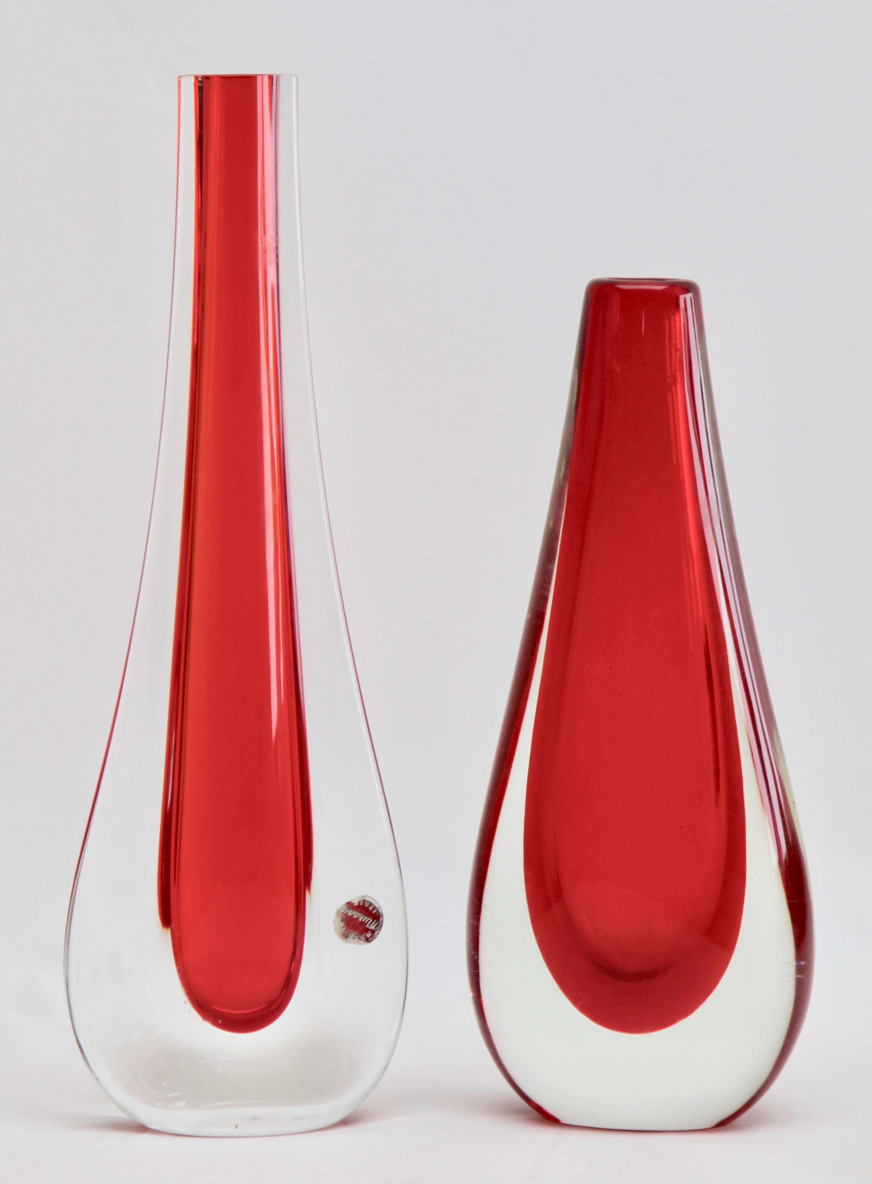 Two similar drop vases after the design by Flavio Poli each with a red core and thick Sommerso (clear glass casing).
This iconic Murano design takes a Minimalist approach to glass design and turns the focus to the skills of the master craftsmen who