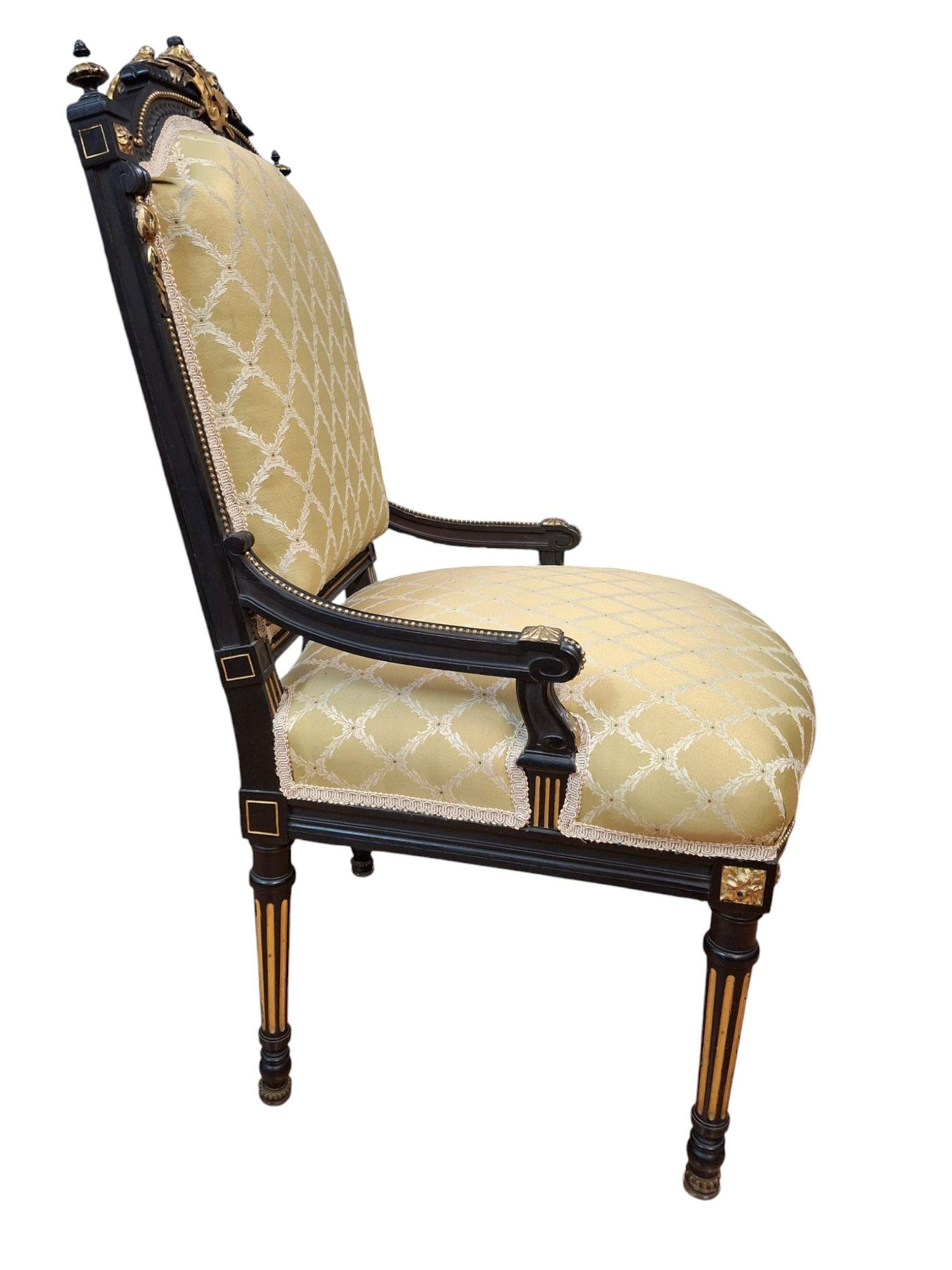 Two Napoleon III style gilt ebonized parlor chairs.

Larger arm chair: 26