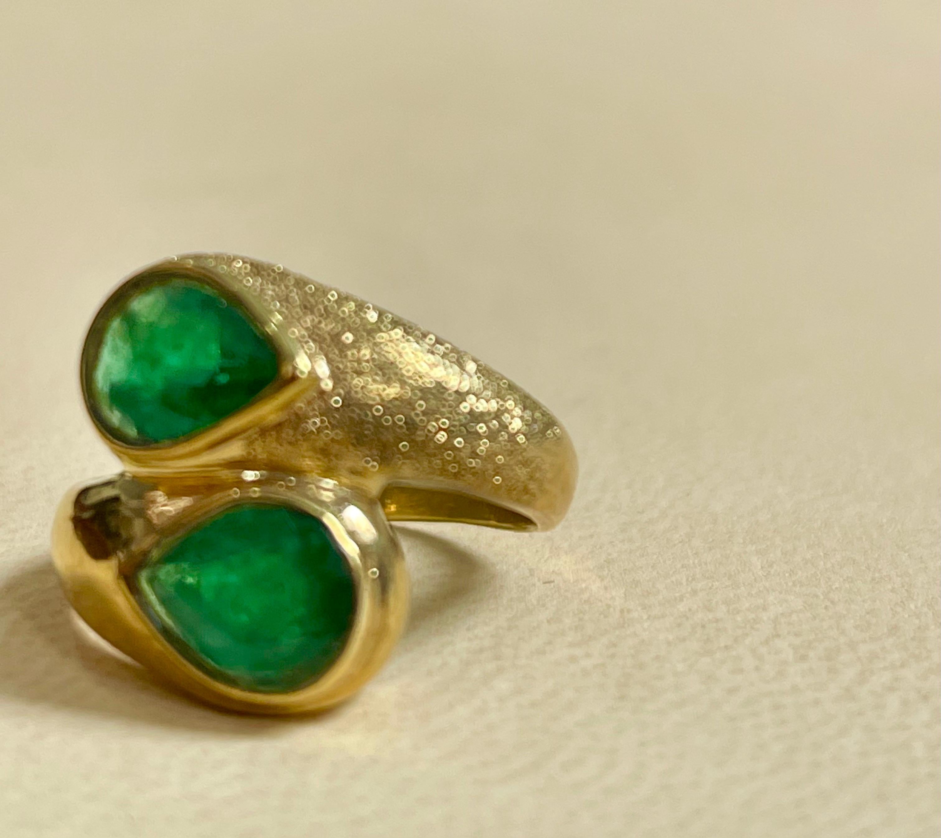 A classic, Cocktail ring 
2 Pear shape  Emerald   Ring 14 Karat Yellow Gold Size 7

Intense green color, Beautiful stone with shine and luster  but has small  inclusions as all natural emeralds have inclusions.  
They have black dots called