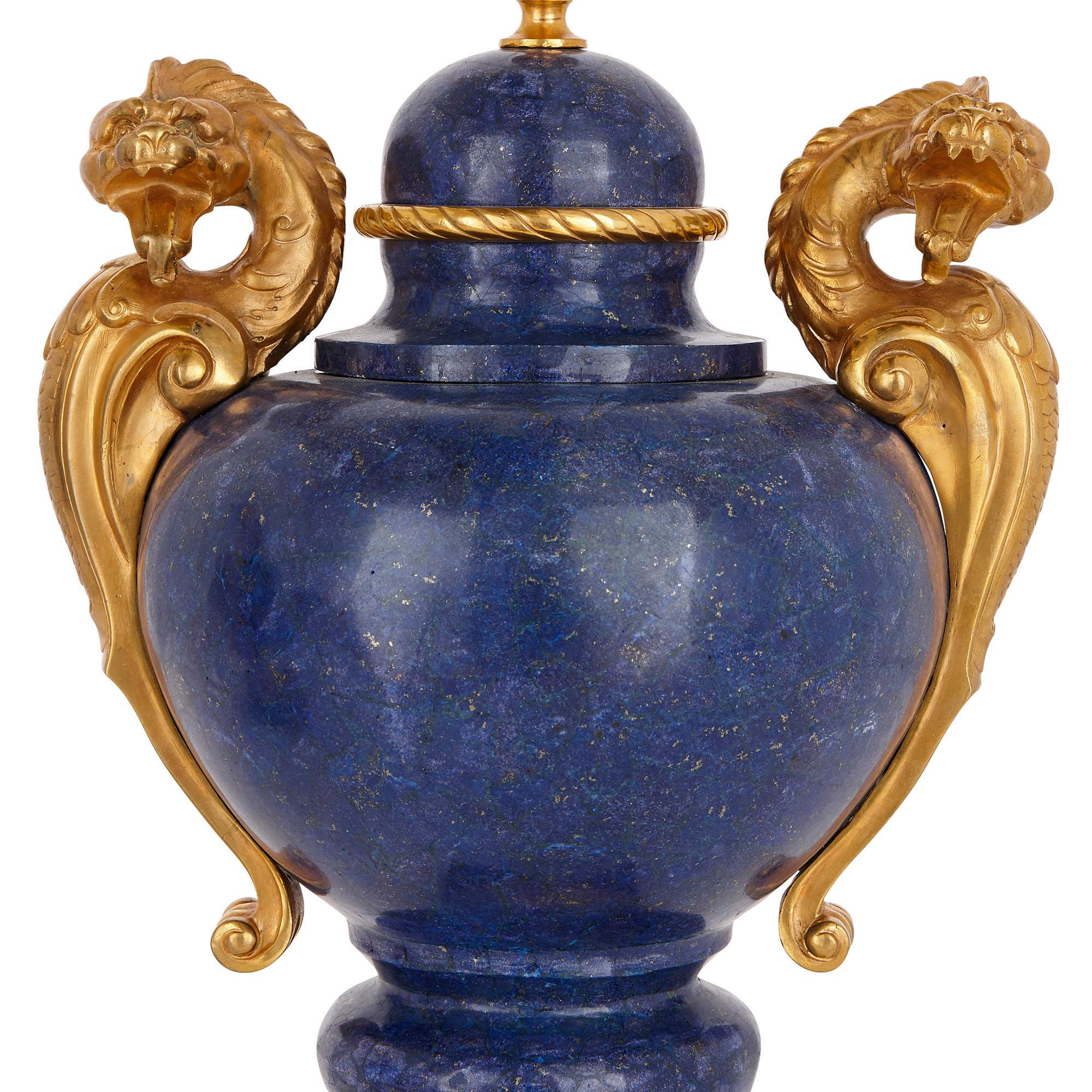 These vases are exceptional pieces of French 19th century luxury design. There is a striking and beautiful contrast created between the rich, blue lapis lazuli veneer (a later addition) and the gilt bronze mounts. 

The lapis lazuli vases are