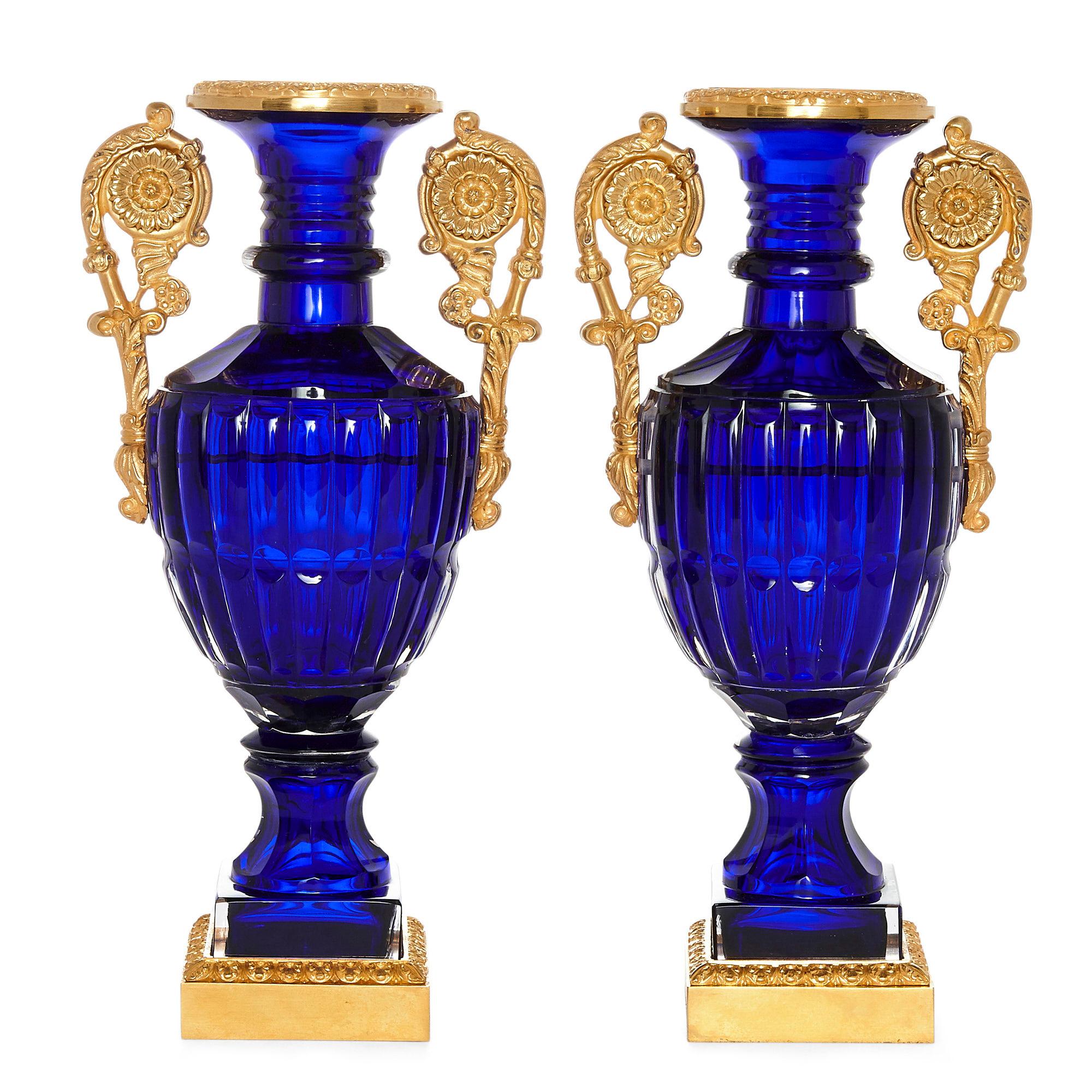 Two neoclassical style Russian cut glass and Ormolu vases
Russian, 20th century
Dimensions: Height 32cm, width 16cm, depth 12cm

Each vase in this pair of Russian neoclassical vases has an ovoid sapphire coloured cut glass body and a flared