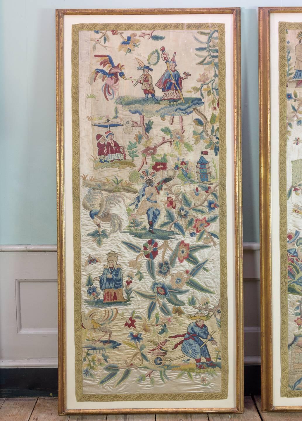 Two English crewel panels, 19th century in the late 17th or early 18th century manner, each silk panel with wool work embroidered decoration and gold braided border, most likely originally part of tester bed drapery, in later gilt frames, with